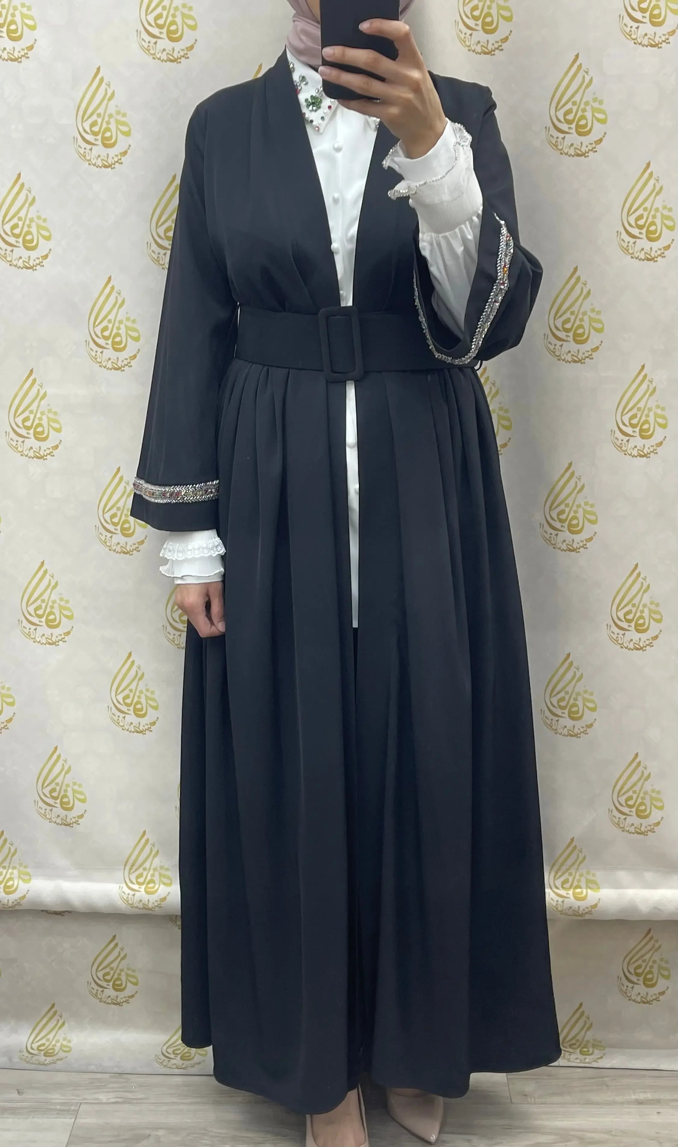 Palestinian Elegance modesty long set featuring a black belted outer garment with decorative sleeves over a white blouse