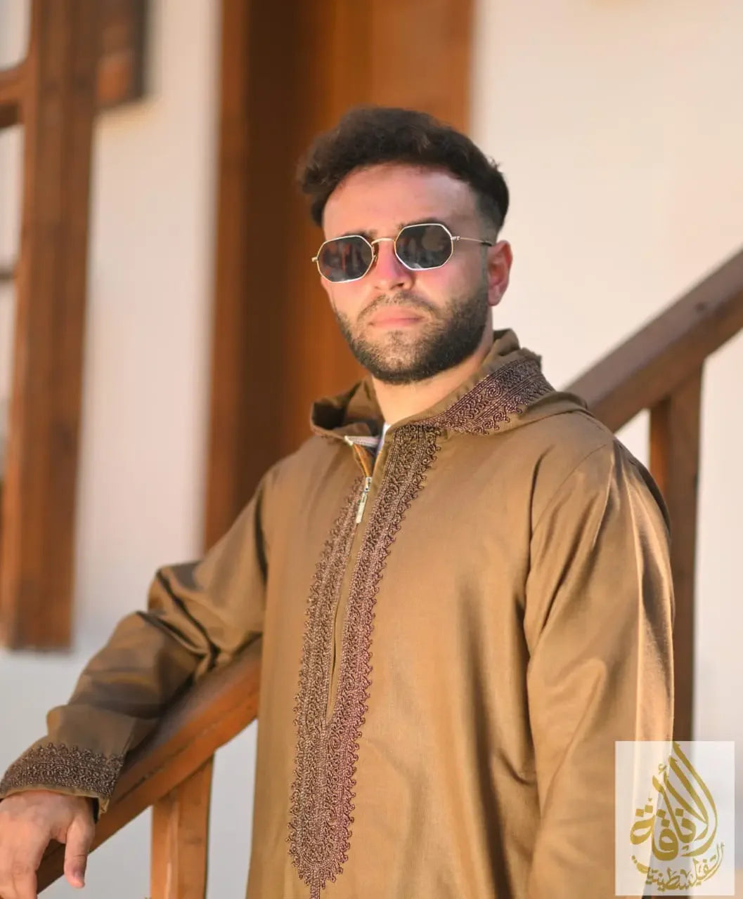 Man wearing brown Moroccan jalabiya for men with detailed embroidery from Palestinian Elegance
