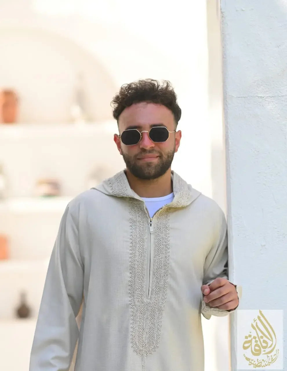 Man wearing a beige Moroccan jalabiya for men with embroidery detailing by Palestinian Elegance