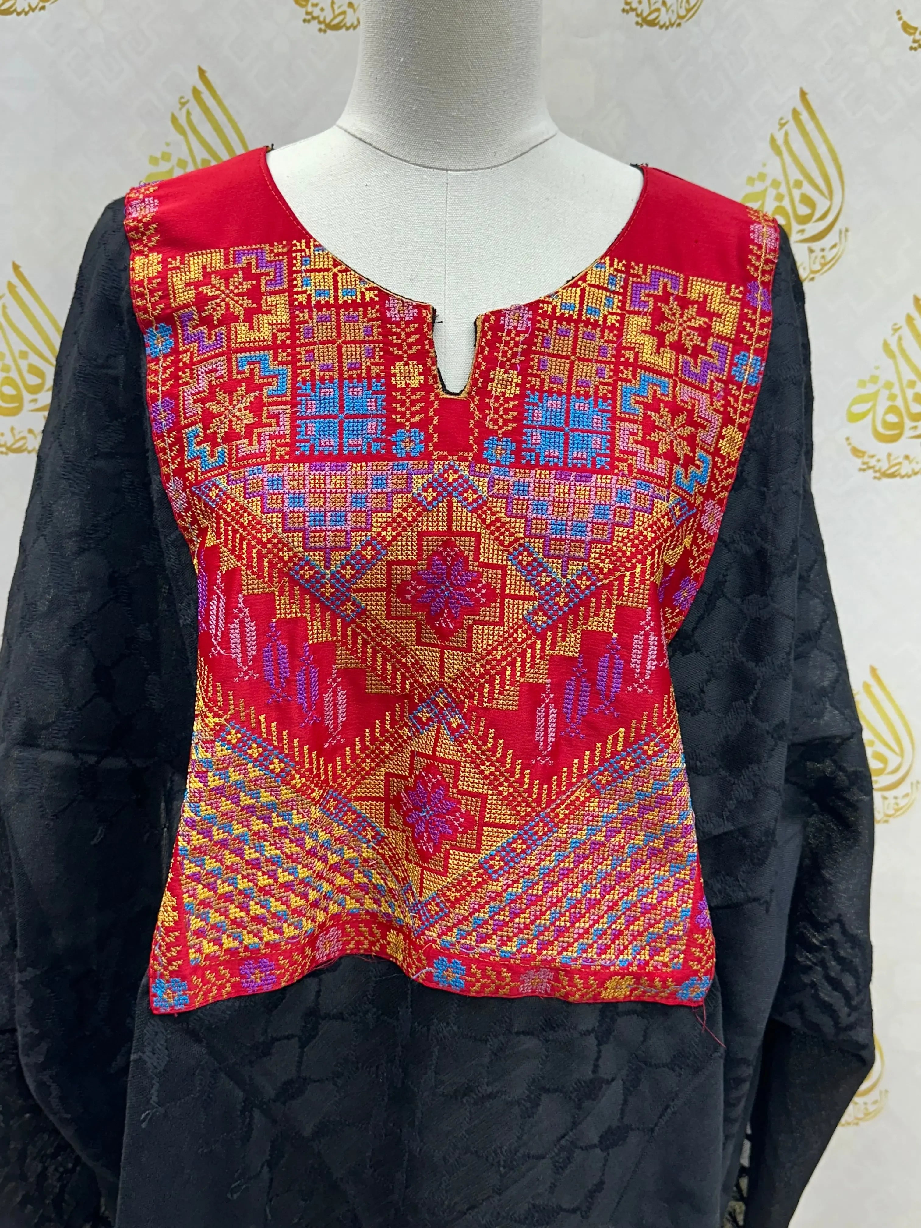 Palestinian Elegance multicolor kuffiyeh shirt with intricate red, blue, and gold embroidery on black casual fabric