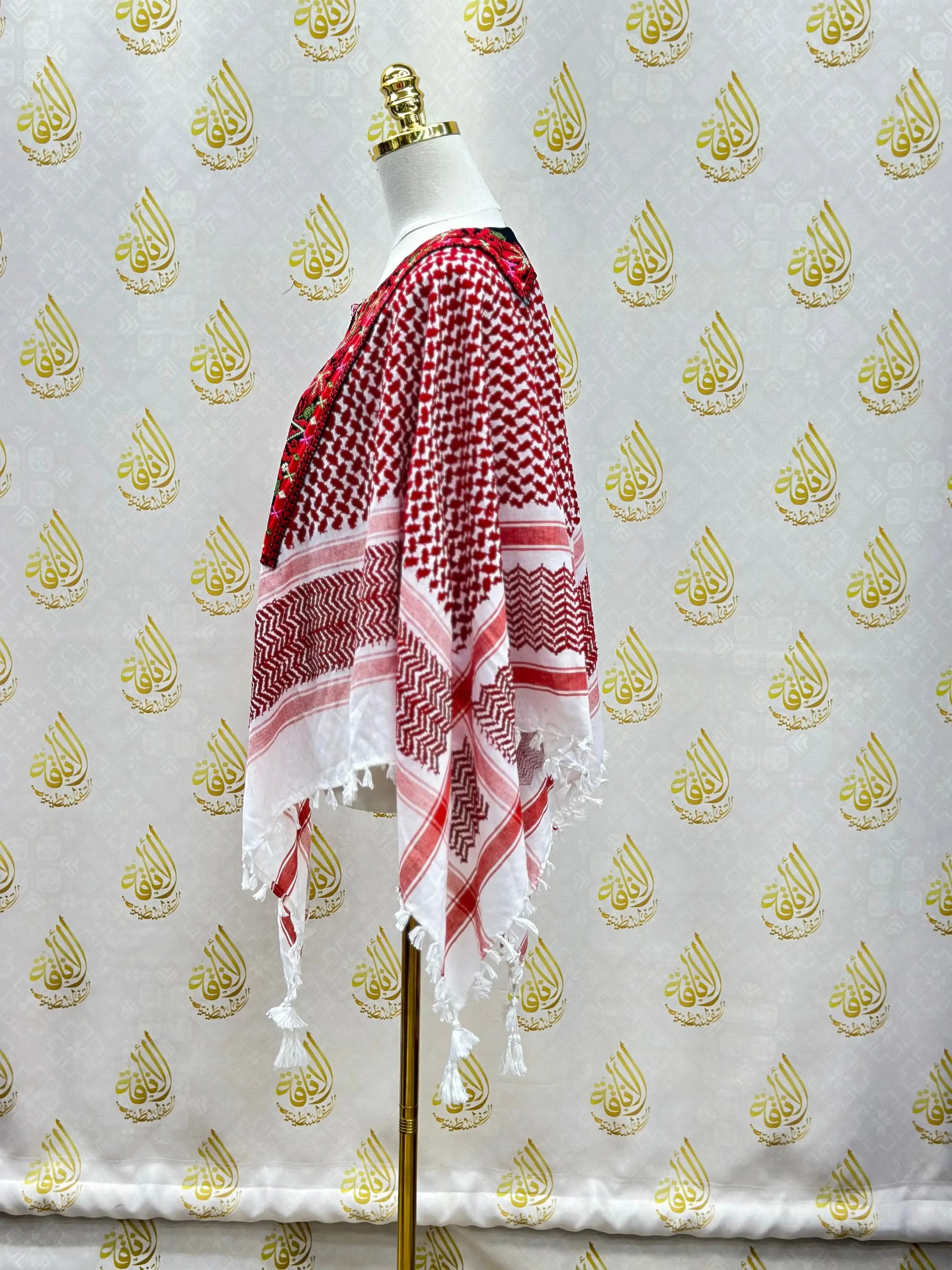 Palestinian Elegance multicolor kuffiyeh shirt displayed on a mannequin with traditional red and white pattern