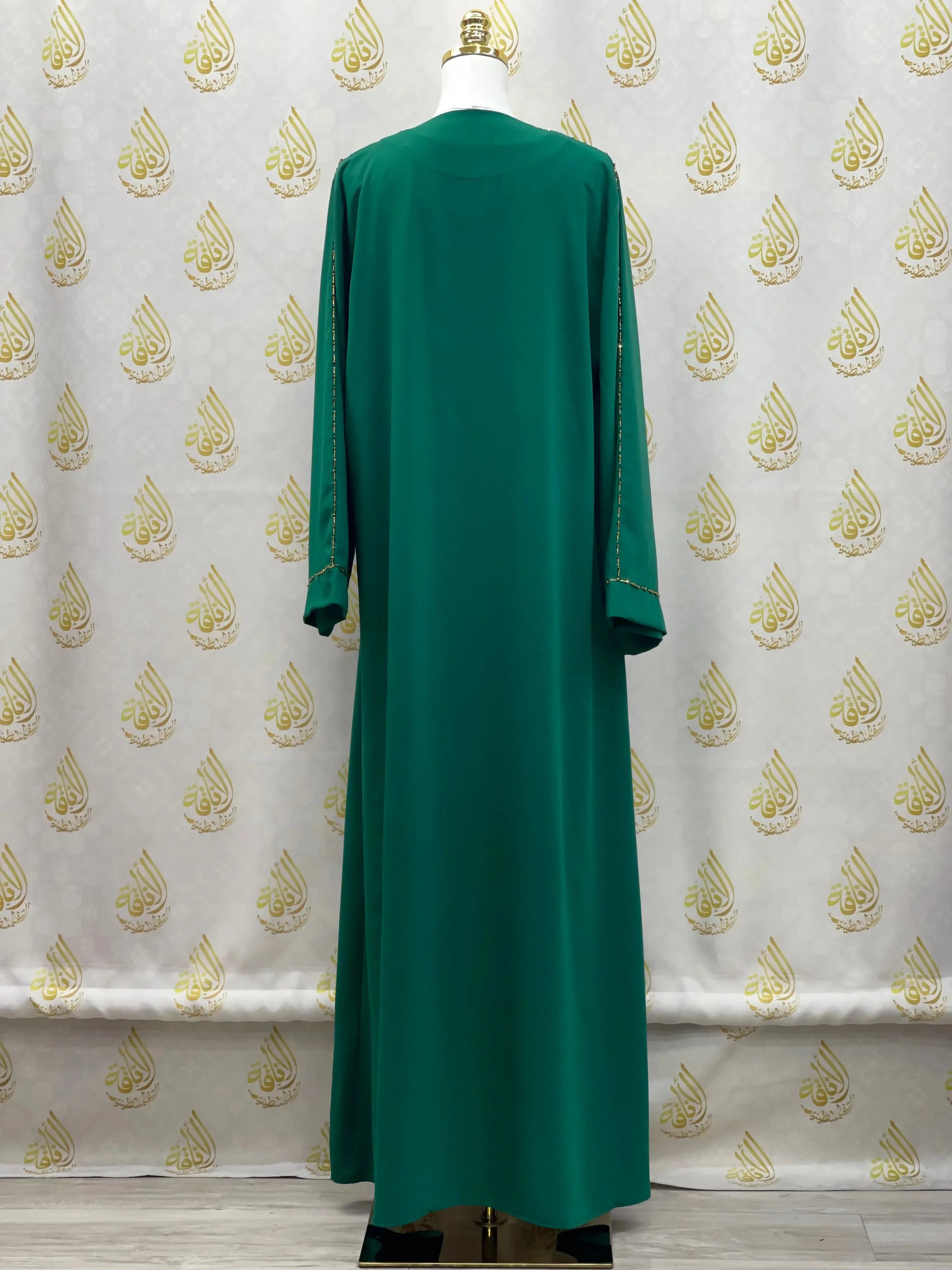 Green open abaya set by Palestinian Elegance with long sleeves and elegant embroidery details