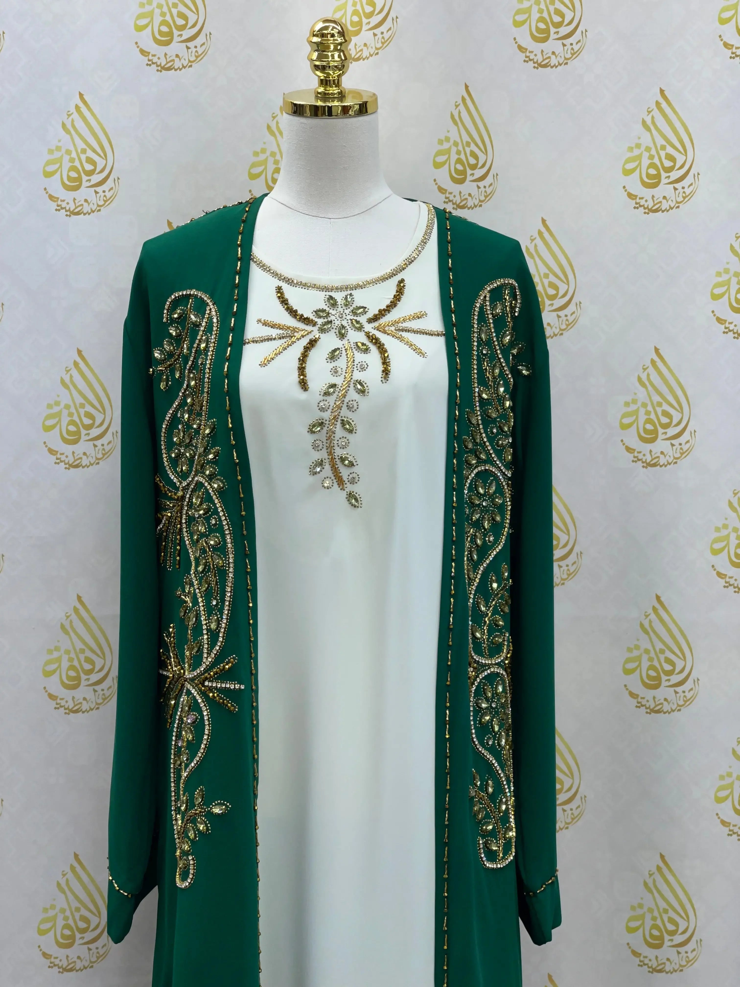 Palestinian Elegance green open abaya set with gold embroidery over white dress on mannequin