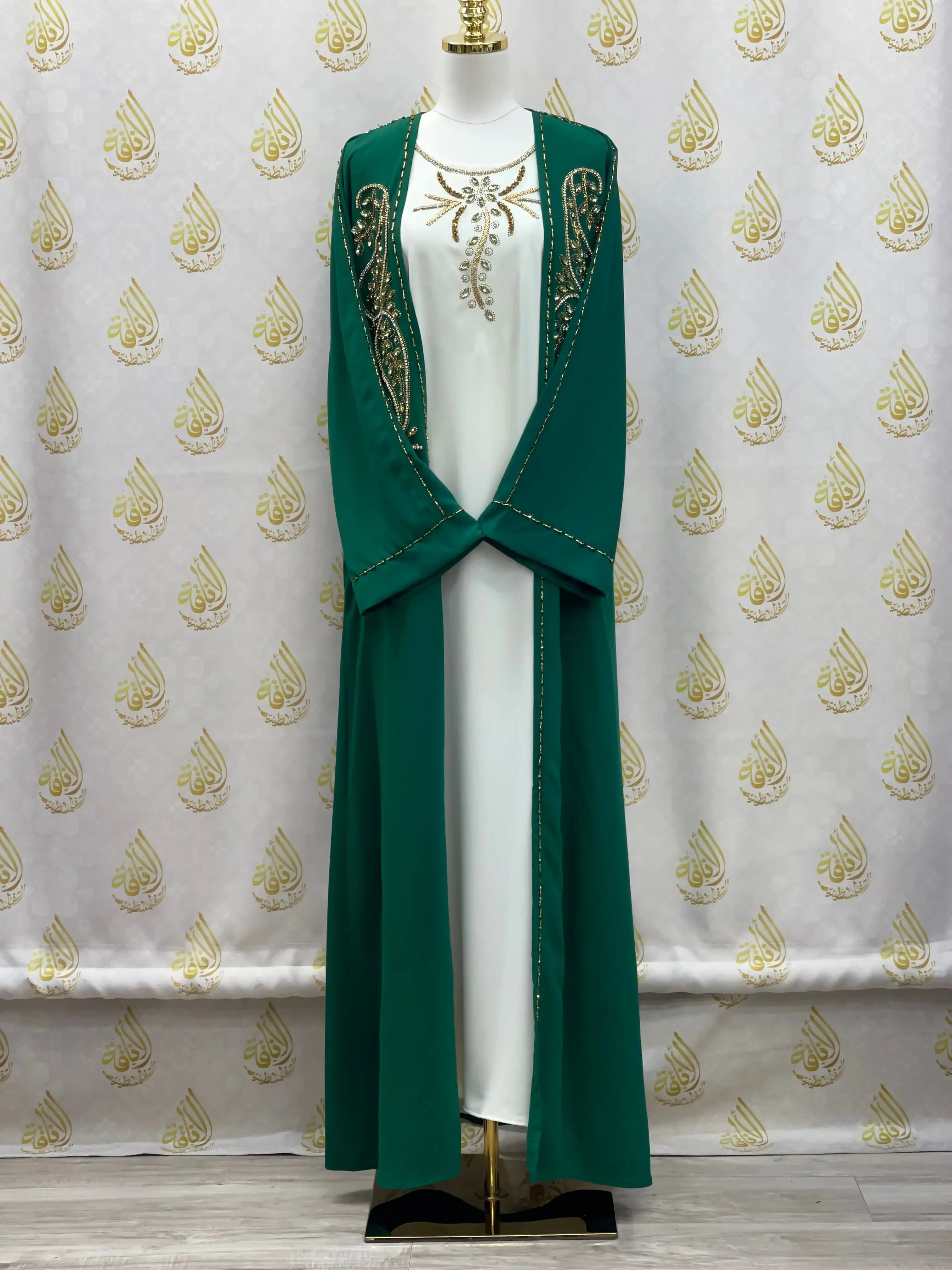 Palestinian Elegance green open abaya set with gold embroidery over white inner dress on mannequin