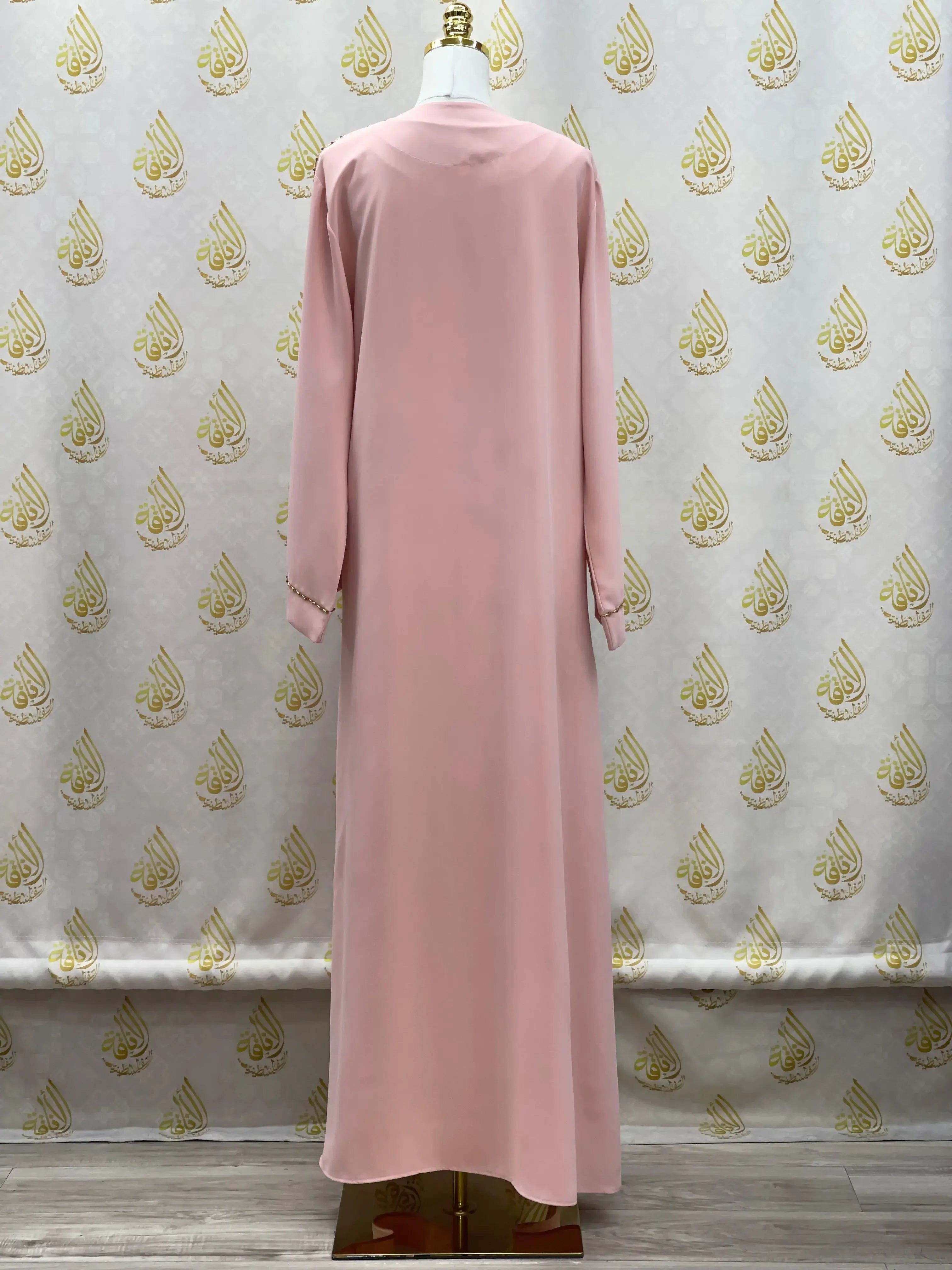 Back view of Palestinian Elegance pink open abaya set displayed on mannequin with long sleeves