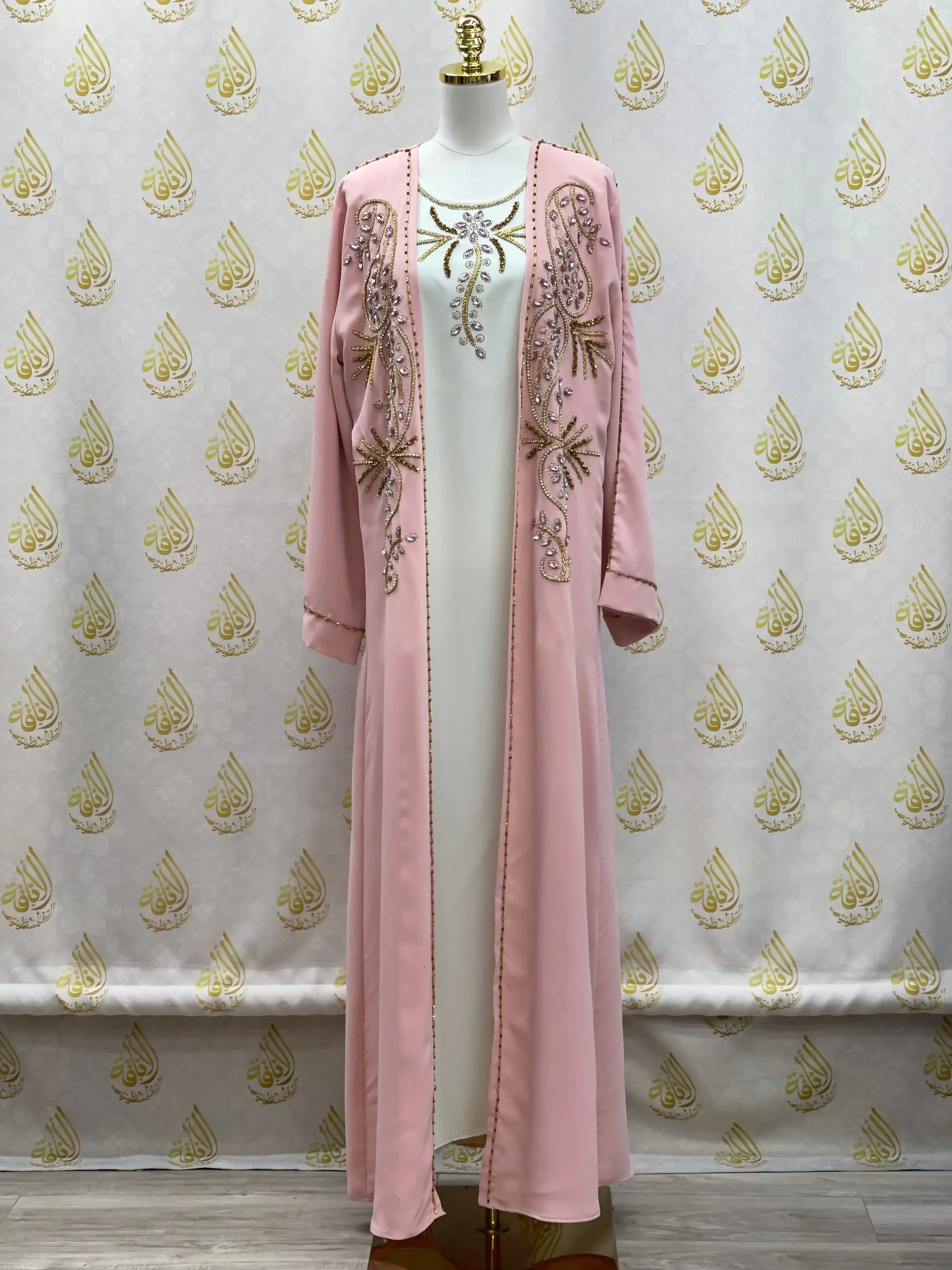 Palestinian Elegance pink open abaya set with intricate beadwork and embroidery on a mannequin