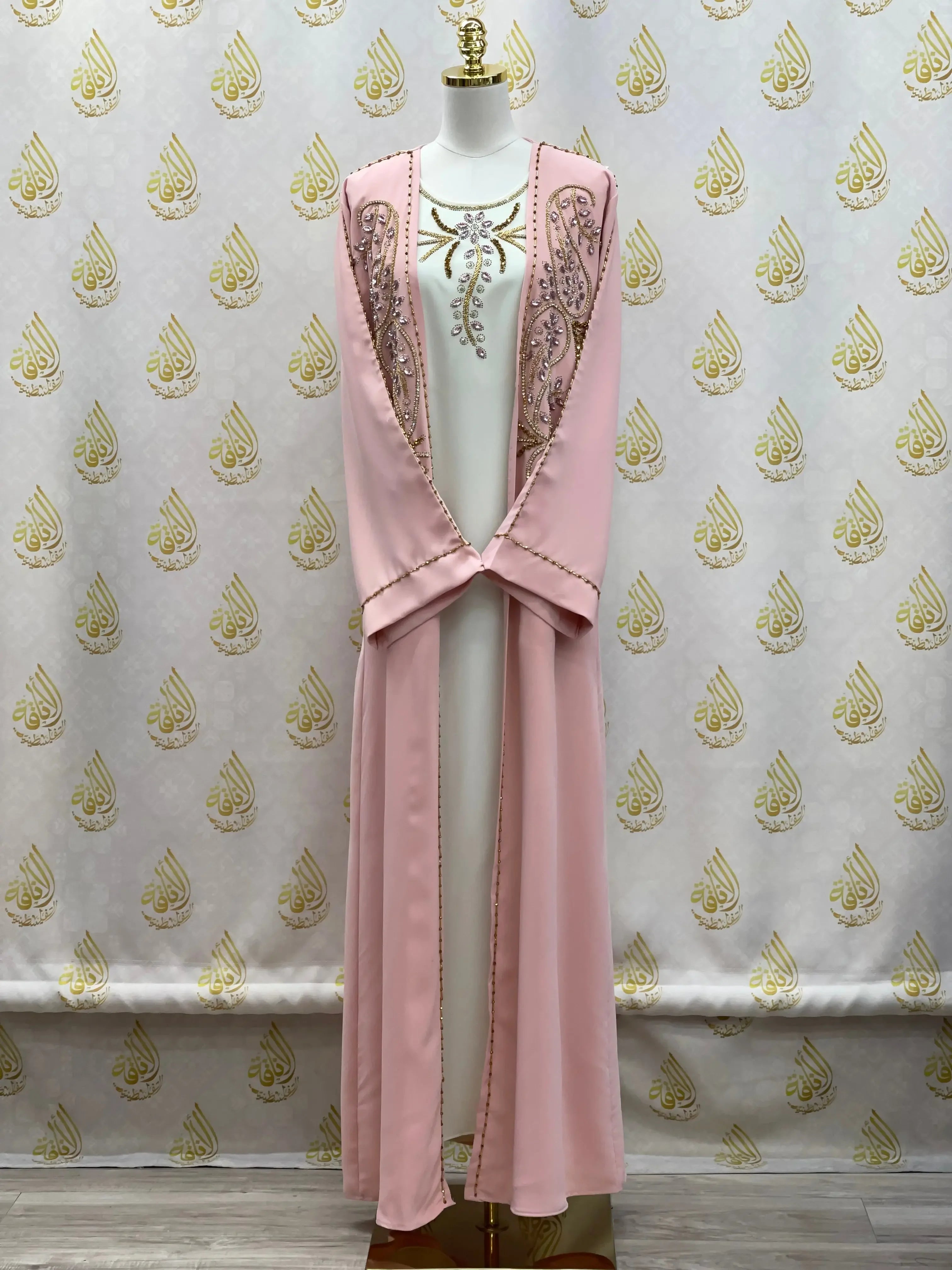 Palestinian Elegance pink embroidered open abaya set displayed on mannequin