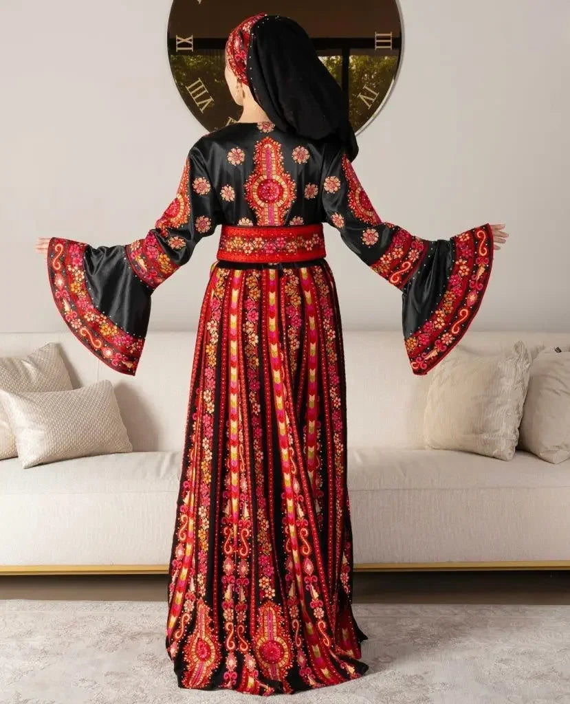 Palestinian bridal thoub dress by Palestinian Elegance featuring intricate red and gold embroidery on black fabric with flared sleeves