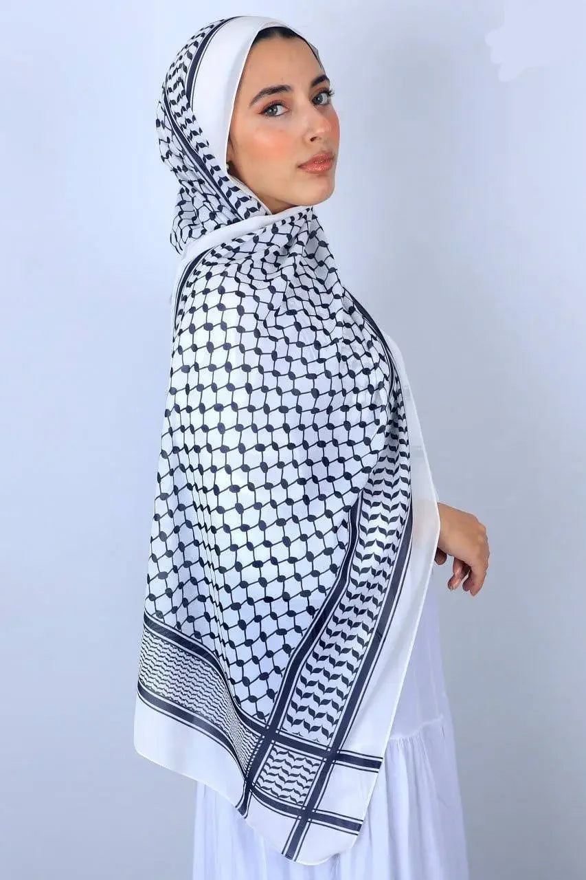 Palestinian chiffon hijab in black and white geometric pattern worn by woman from Palestinian Elegance
