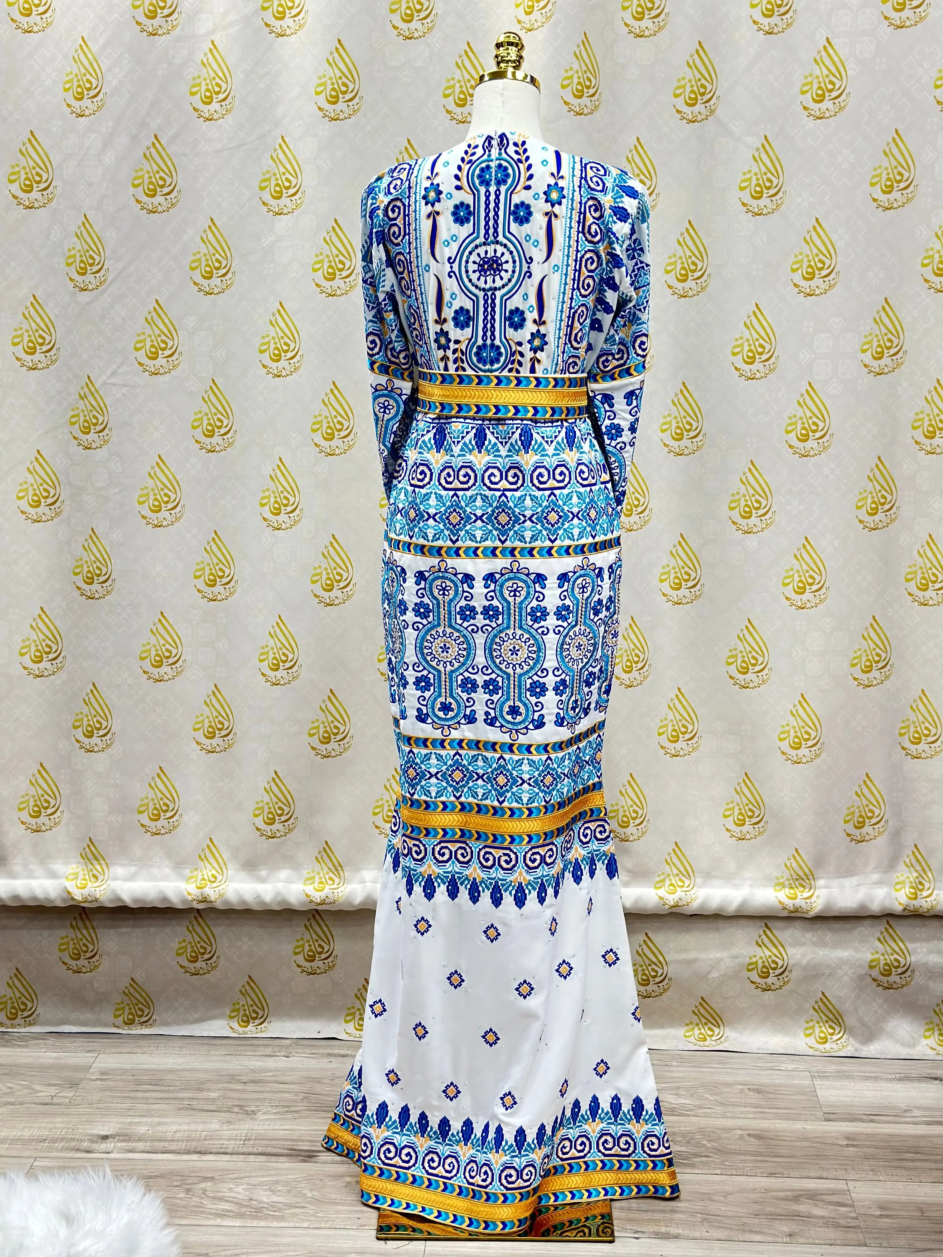 Palestinian embroidered dress bridal gown with blue and yellow traditional patterns by Palestinian Elegance