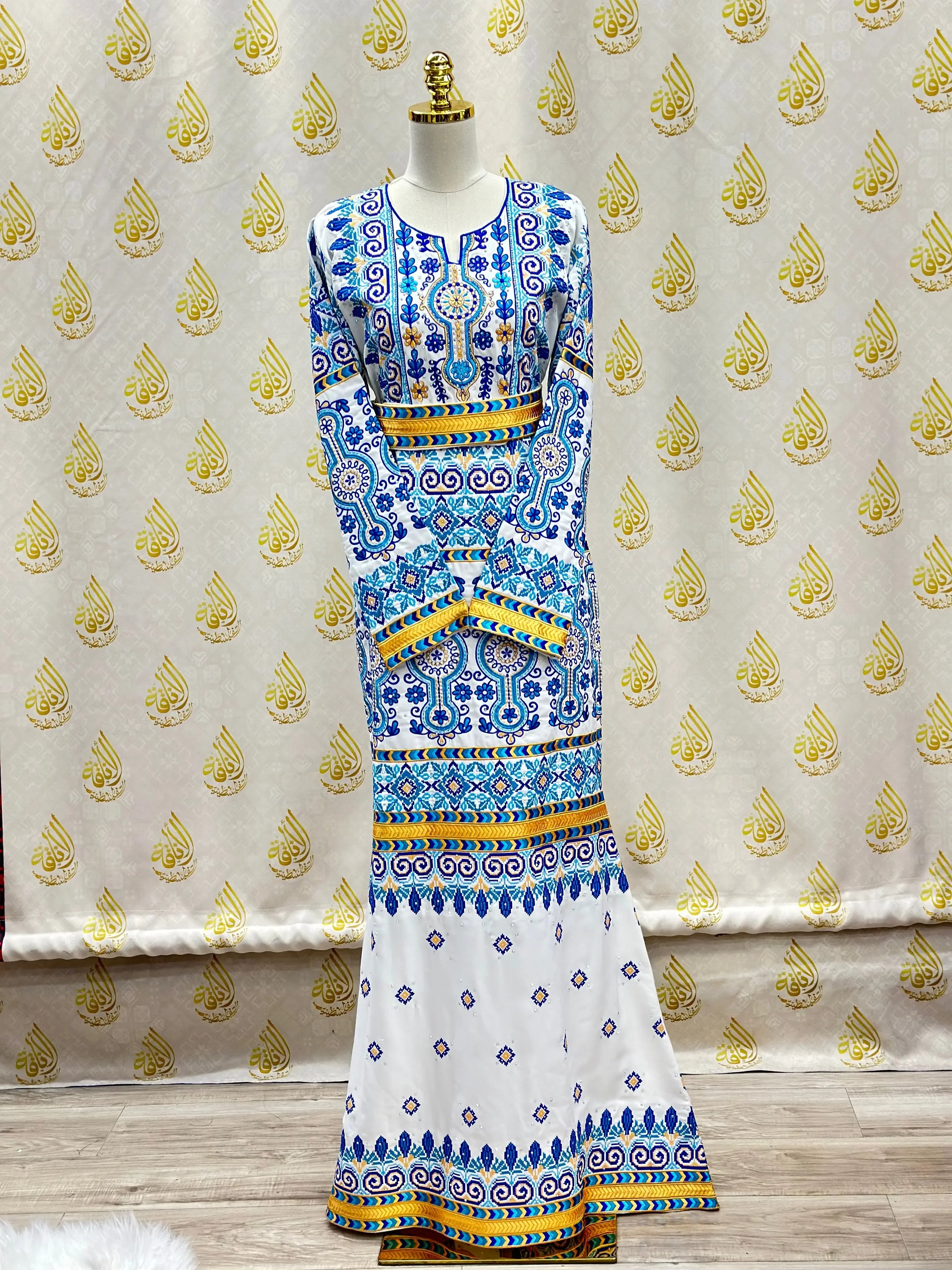 Palestinian embroidered dress with intricate blue and yellow patterns full-length bridal gown