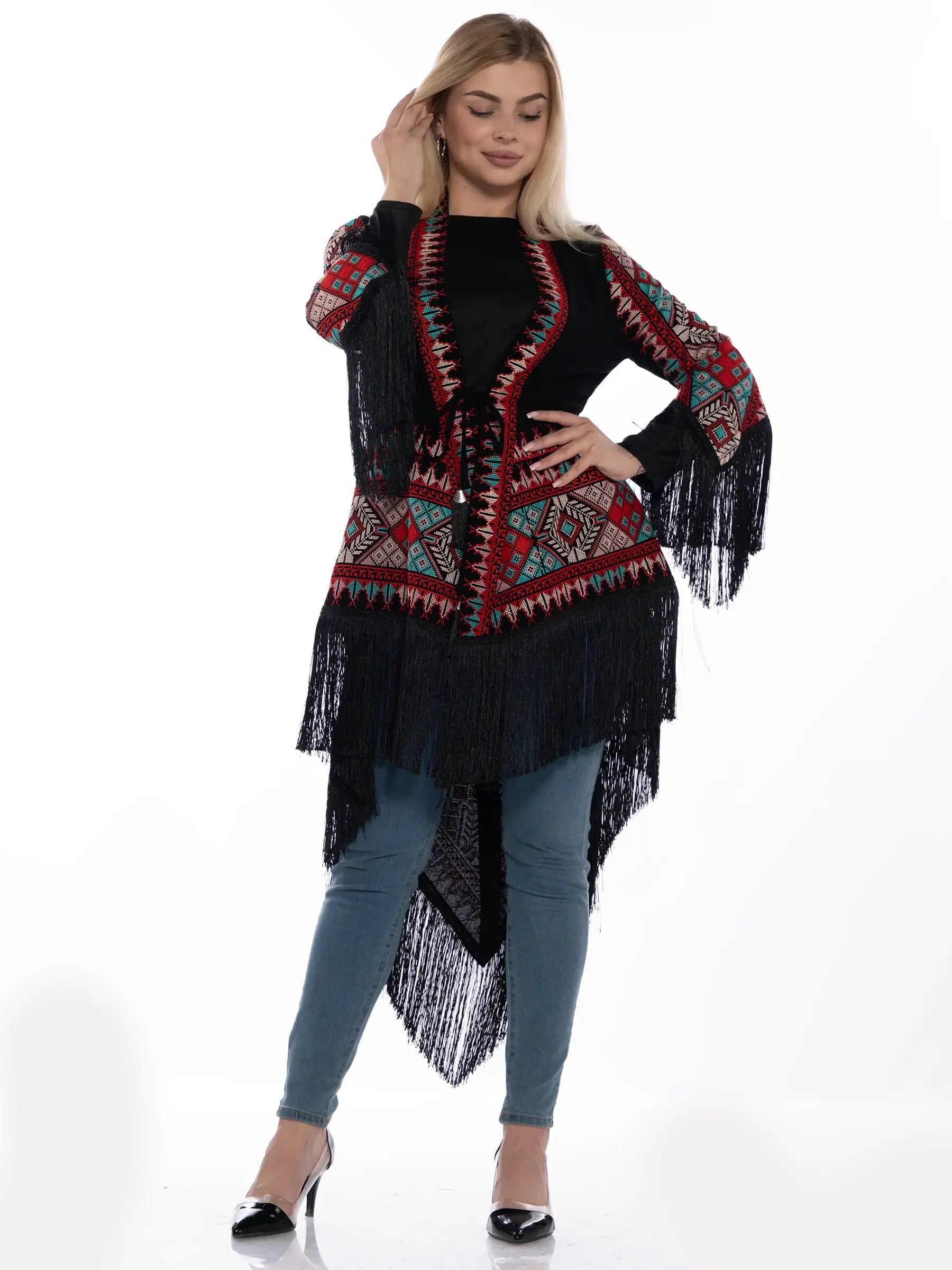 Woman wearing a Palestinian embroidered kimono with colorful patterns and fringe detailing