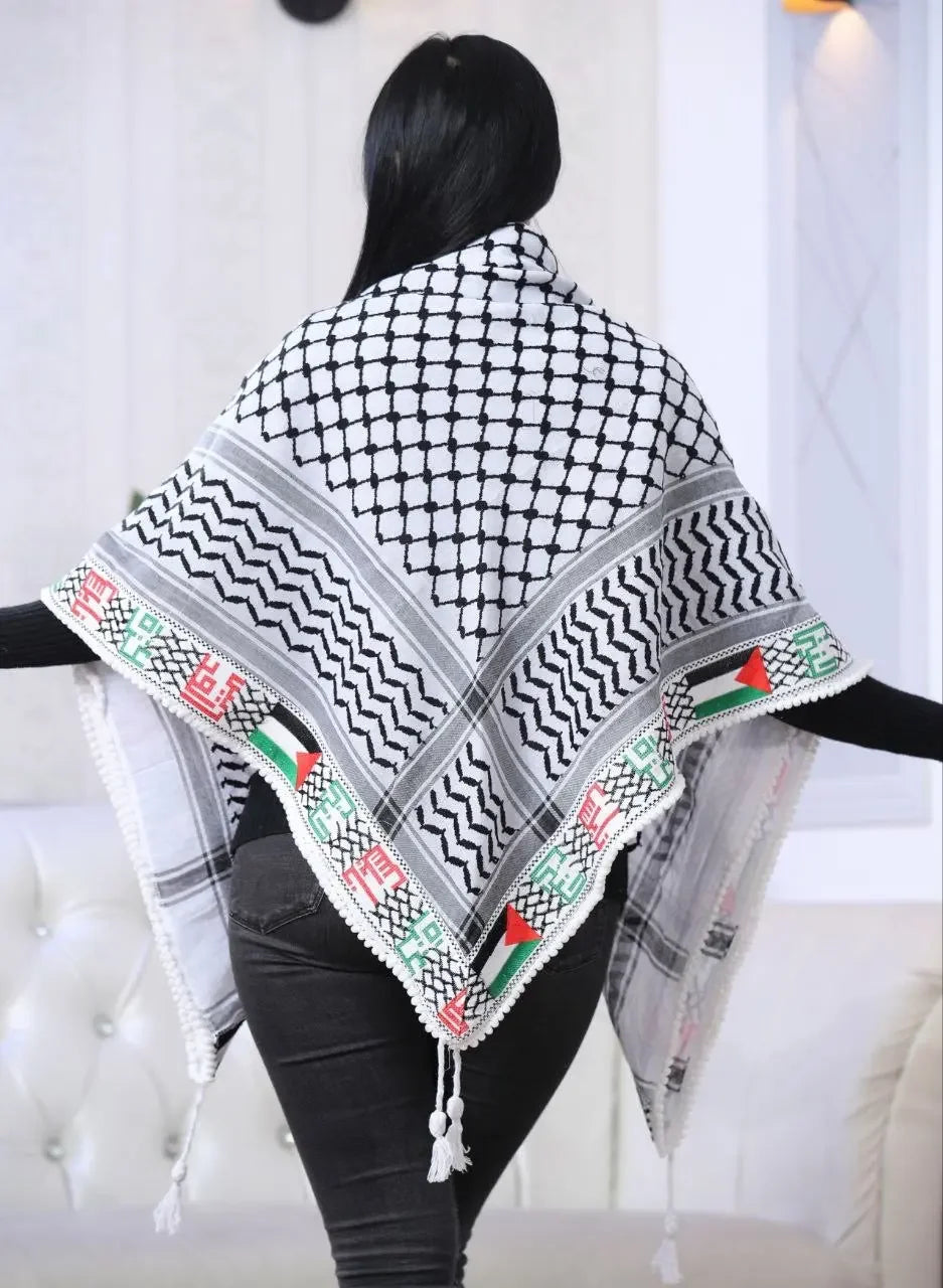 Palestinian embroidered kuffiyeh draped over shoulders featuring traditional black and white patterns with colorful border