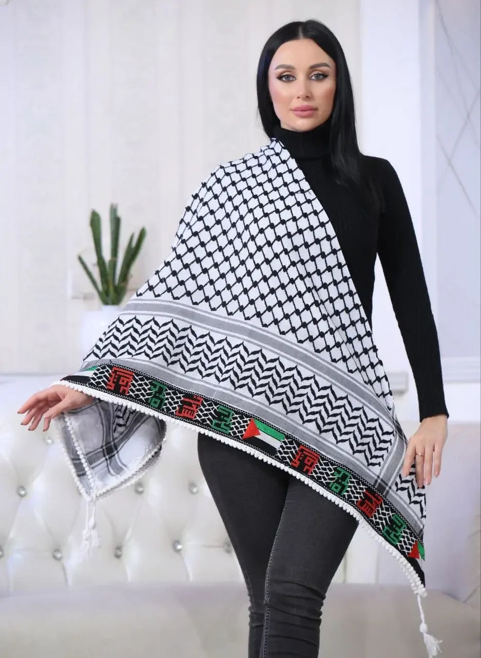 Woman wearing black outfit draped with Palestinian embroidered kuffiyeh featuring traditional black and white patterns and colorful accents