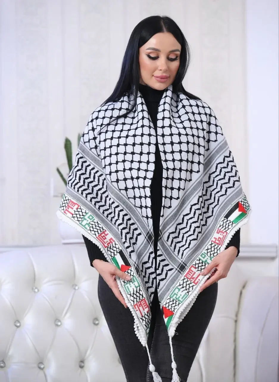 Woman wearing a Palestinian embroidered kuffiyeh shawl with traditional black white and red green patterns