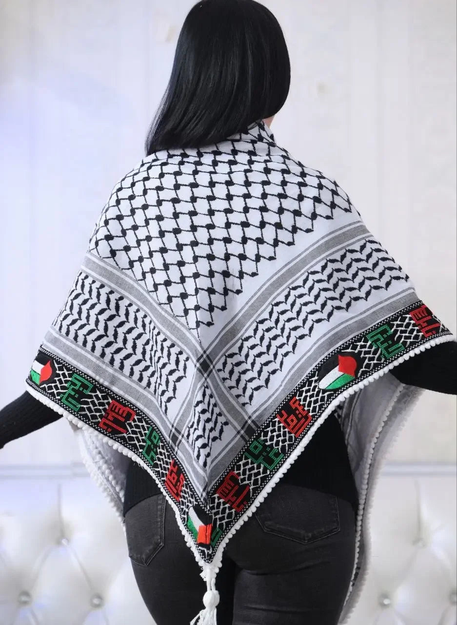 Woman wearing embroidered Palestinian kuffiyeh with traditional black and white pattern and colorful border from Palestinian Elegance