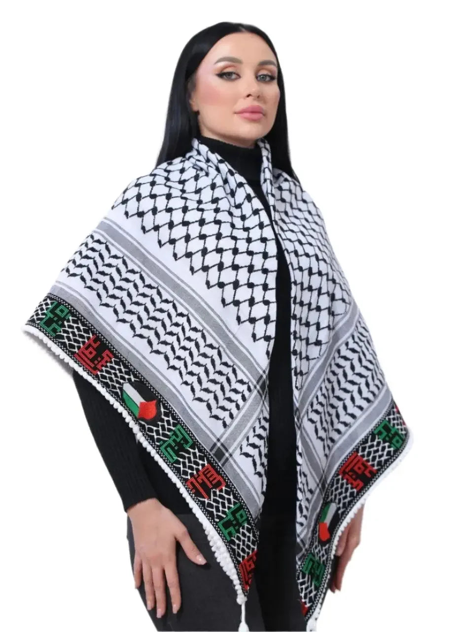 Woman wearing an embroidered Palestinian kuffiyeh with traditional black and white patterns and colorful border accents