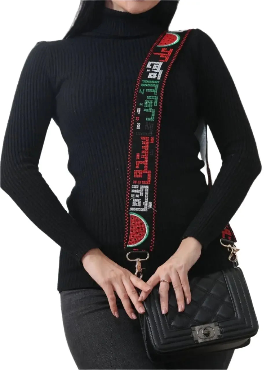 Palestinian embroidered purse strap with traditional patterns and watermelon design on a black purse