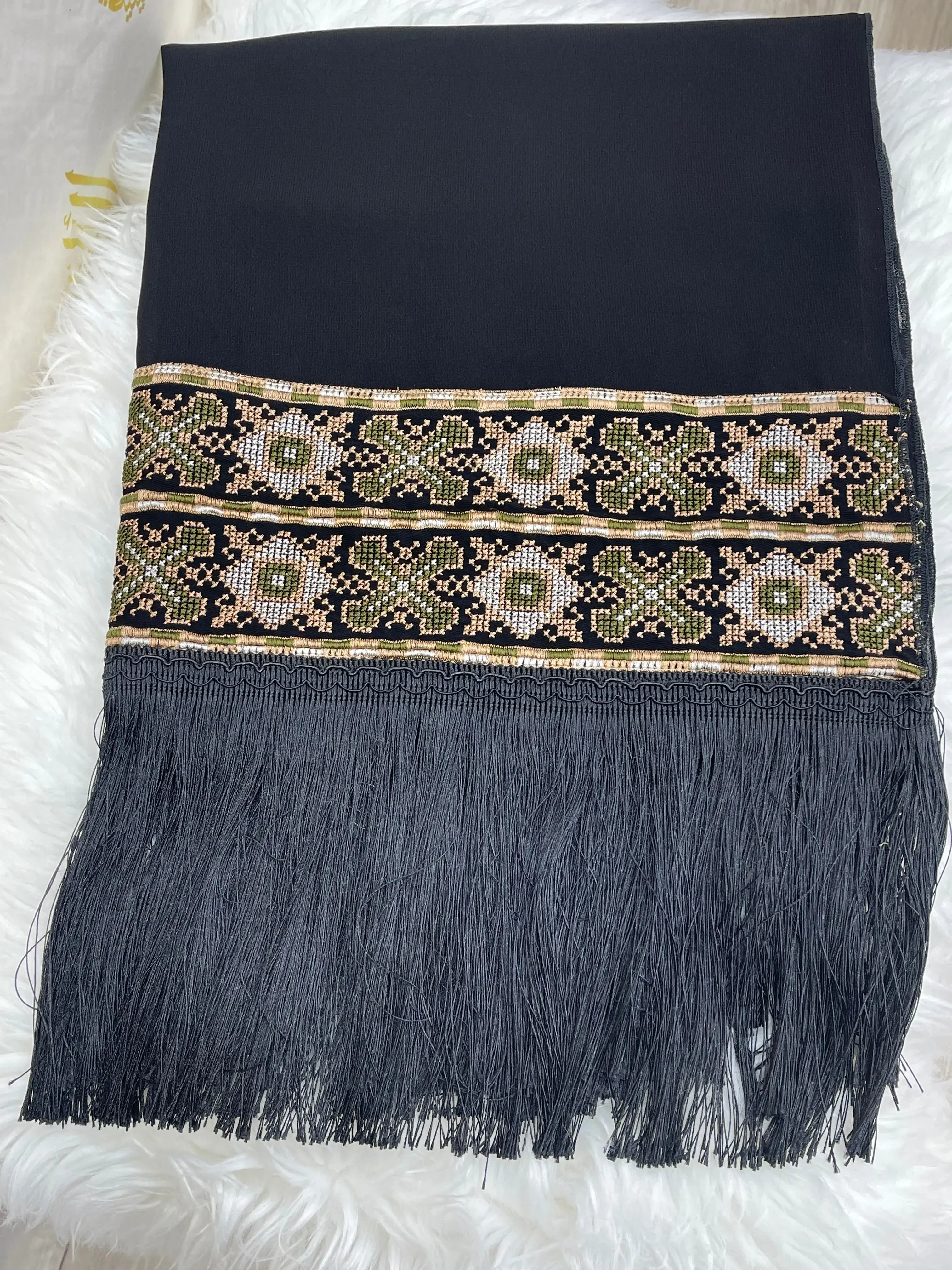 Black Palestinian embroidered shawl with intricate floral patterns and long fringes from Palestinian Elegance