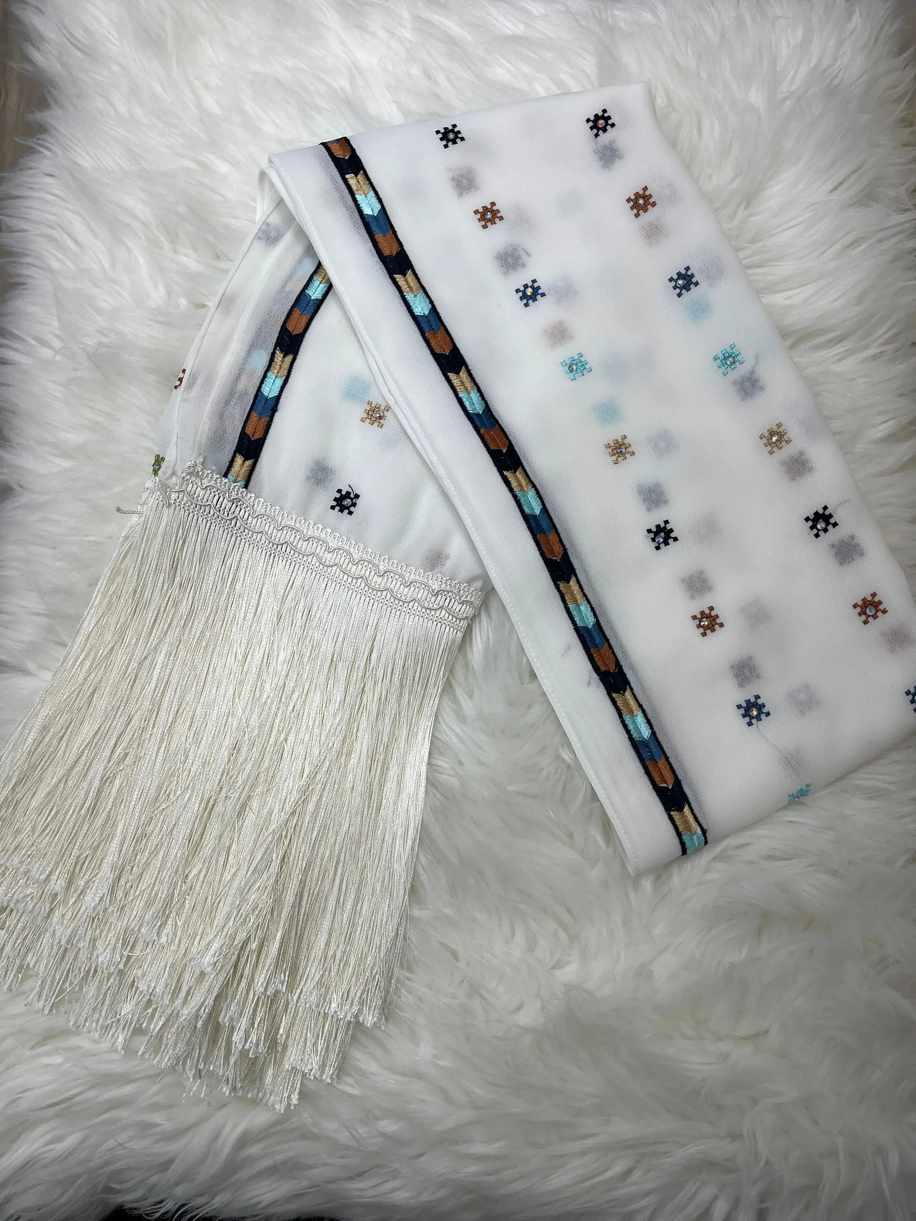 Palestinian embroidered shawl in white with colorful geometric patterns and long white tassels