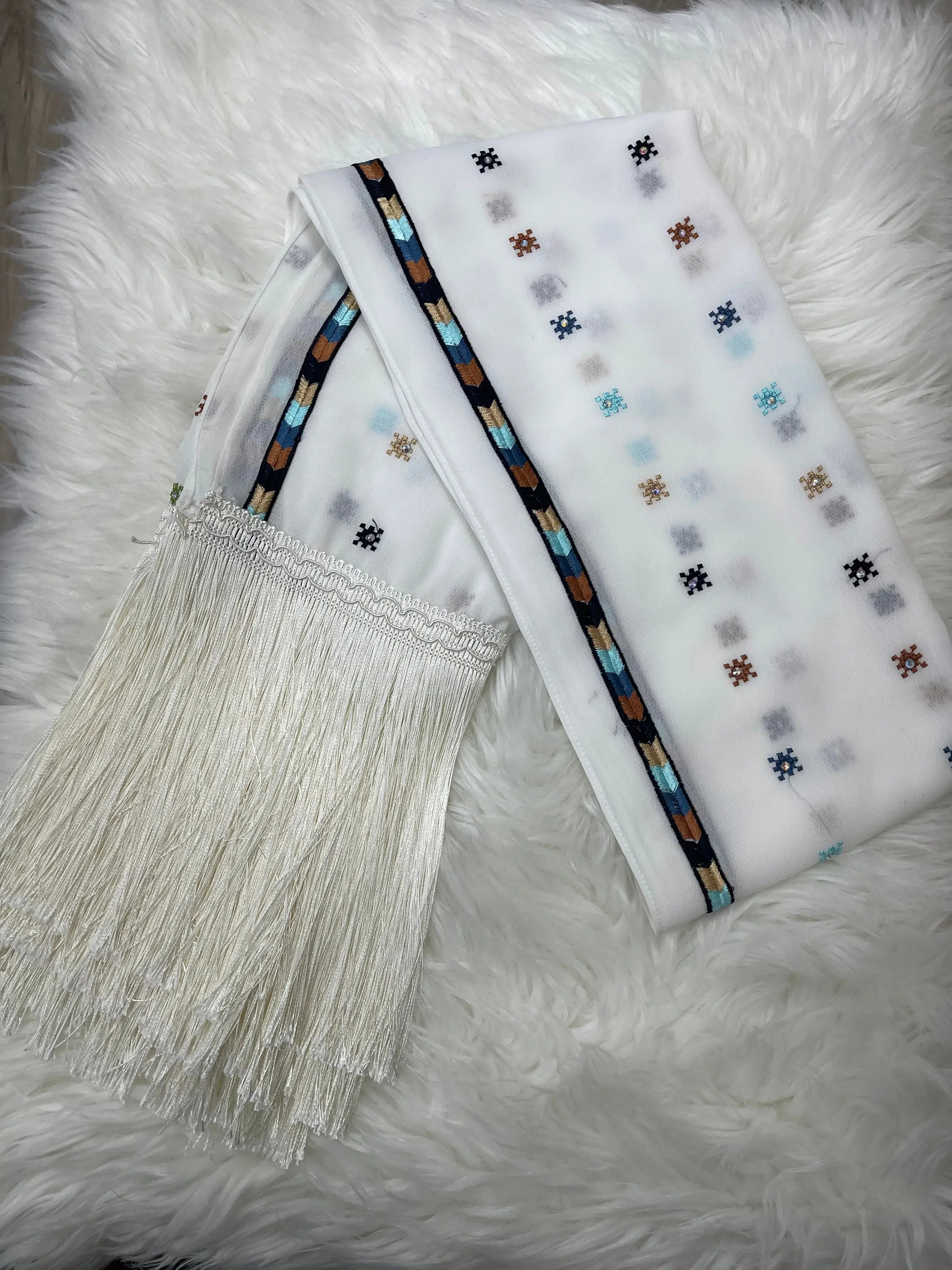 Palestinian embroidered shawl with colorful geometric patterns and long white fringe detailing