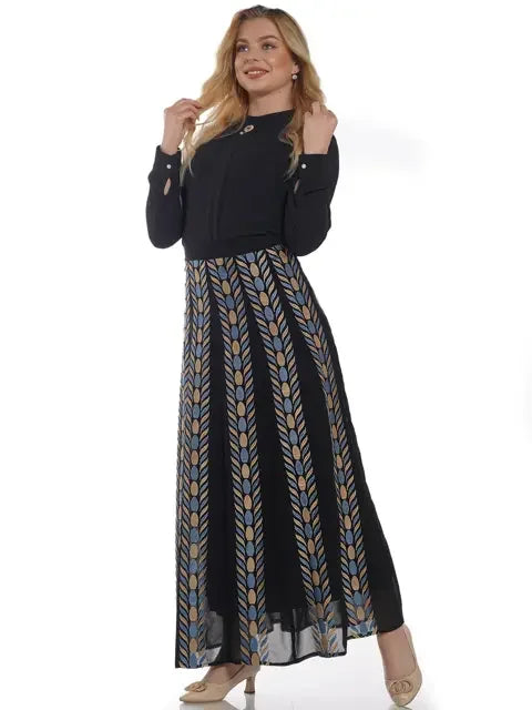 Woman wearing a Palestinian embroidered skirt with a black top and beige heels in a casual outfit