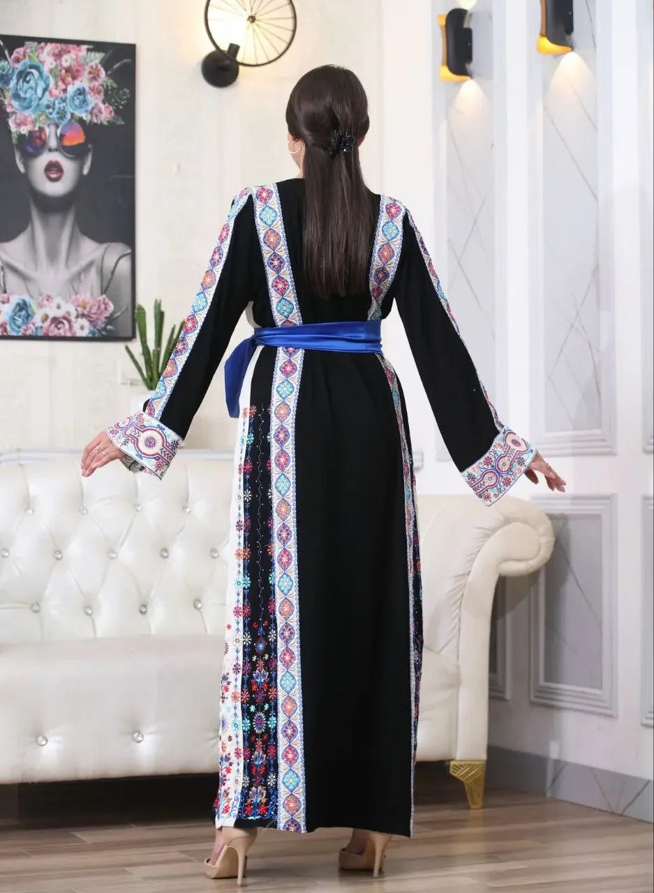Palestinian embroidered thobe in black with colorful geometric embroidery and blue waist belt by Palestinian Elegance