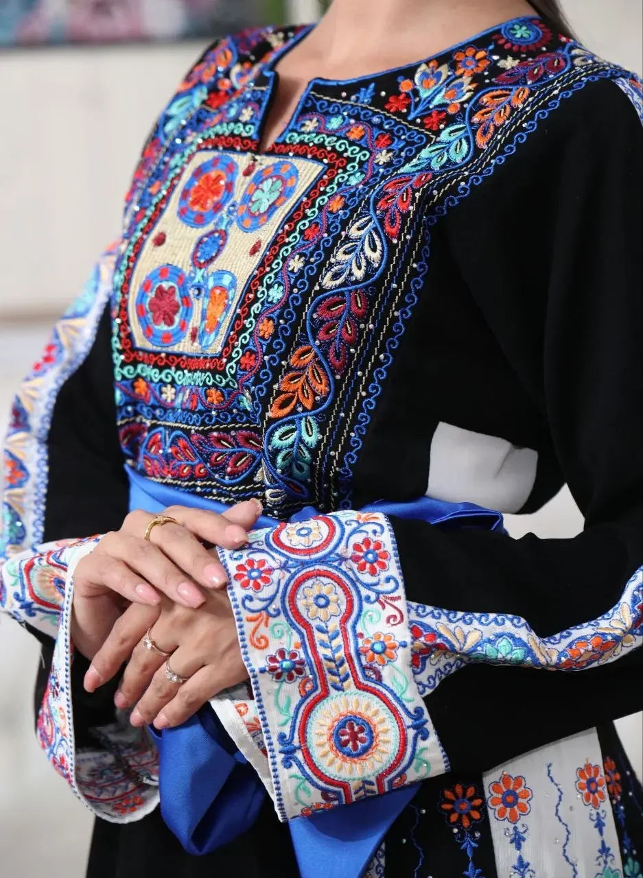 Palestinian embroidered thobe by Palestinian Elegance with intricate colorful embroidery on black fabric