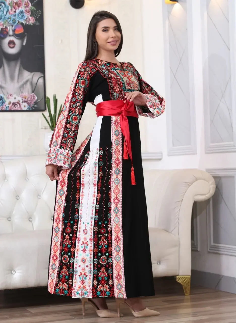 Palestinian embroidered thobe with intricate red and black embroidery and a red waist sash by Palestinian Elegance