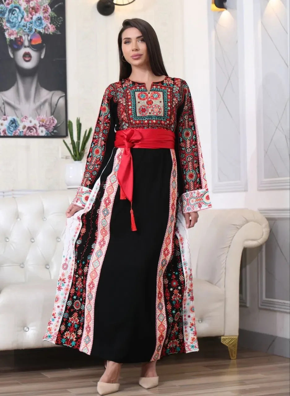 Palestinian embroidered thobe by Palestinian Elegance with red, black, and white intricate embroidery and a red waist sash