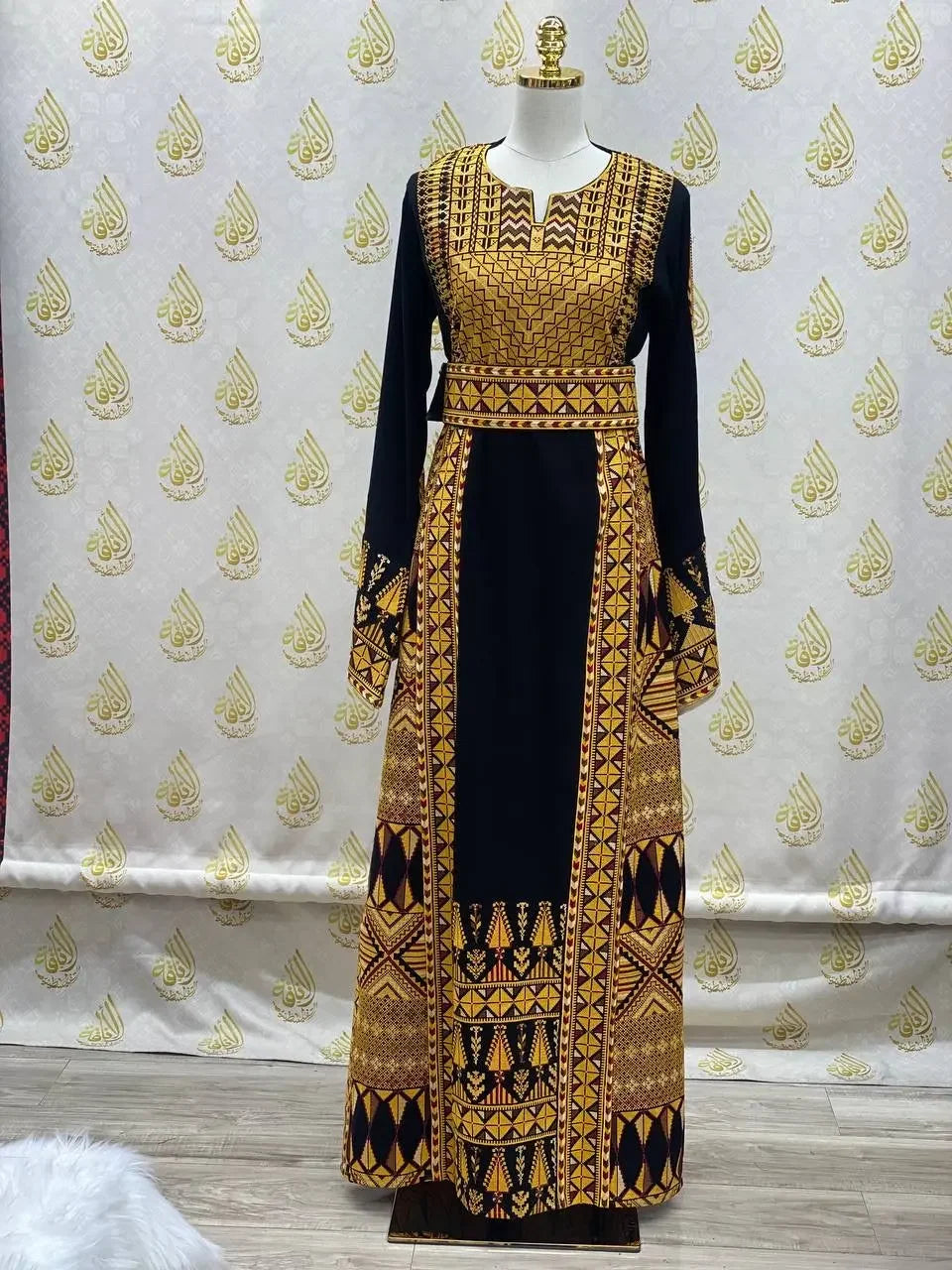 Palestinian embroidered thobe dress in black with intricate yellow and gold traditional embroidery details