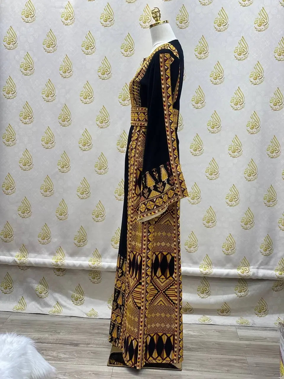 Palestinian embroidered thobe dress in black with intricate gold geometric embroidery by Palestinian Elegance