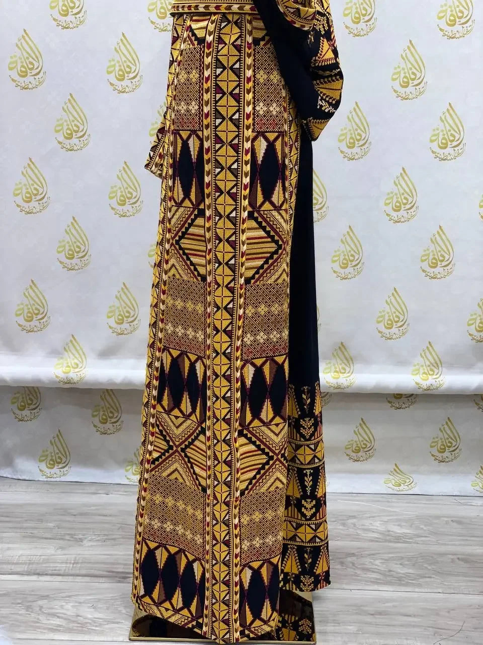 Palestinian embroidered thobe dress with intricate geometric patterns and rich colors by Palestinian Elegance