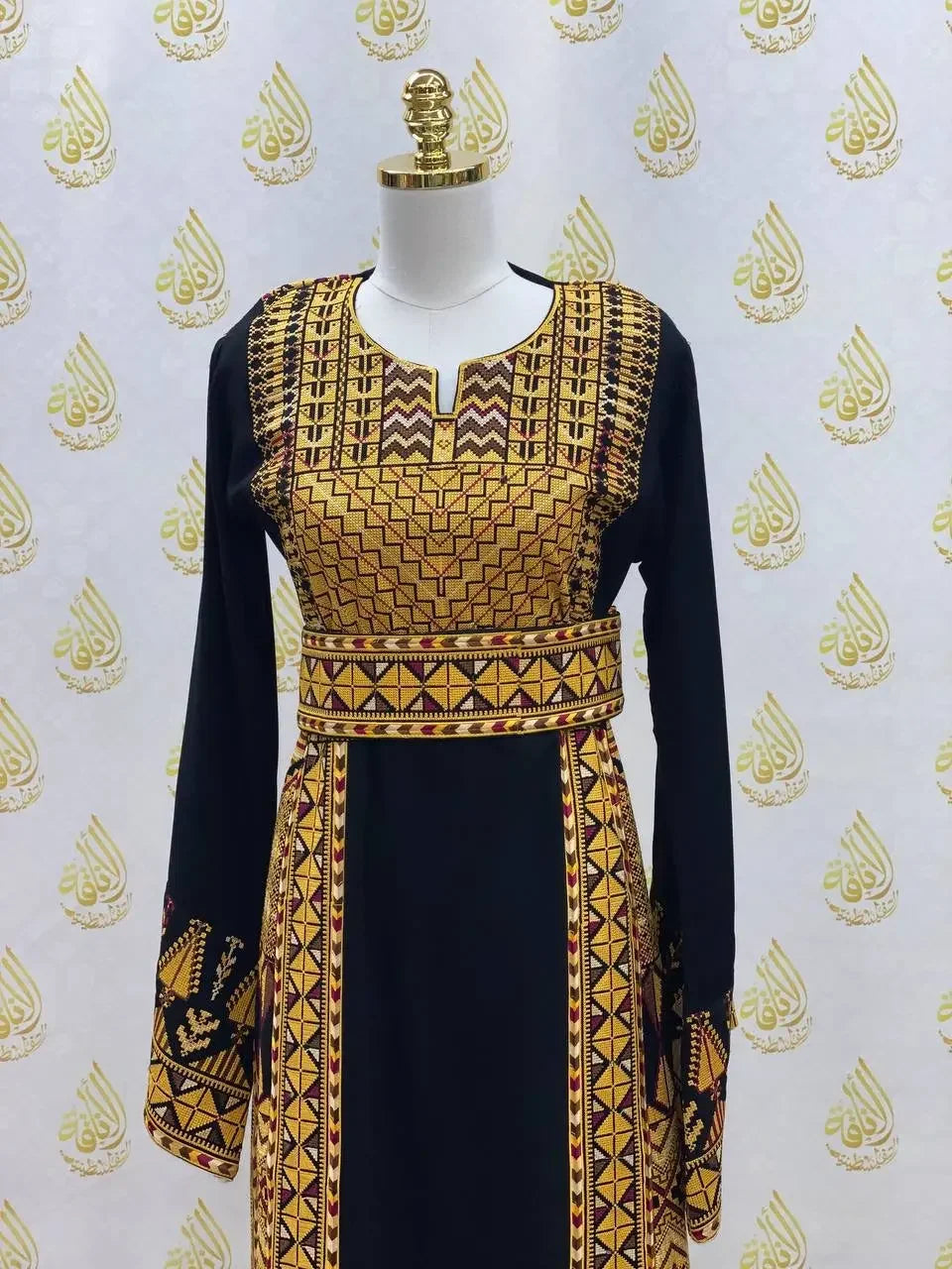Palestinian embroidered thobe dress in black with intricate golden embroidery and geometric patterns