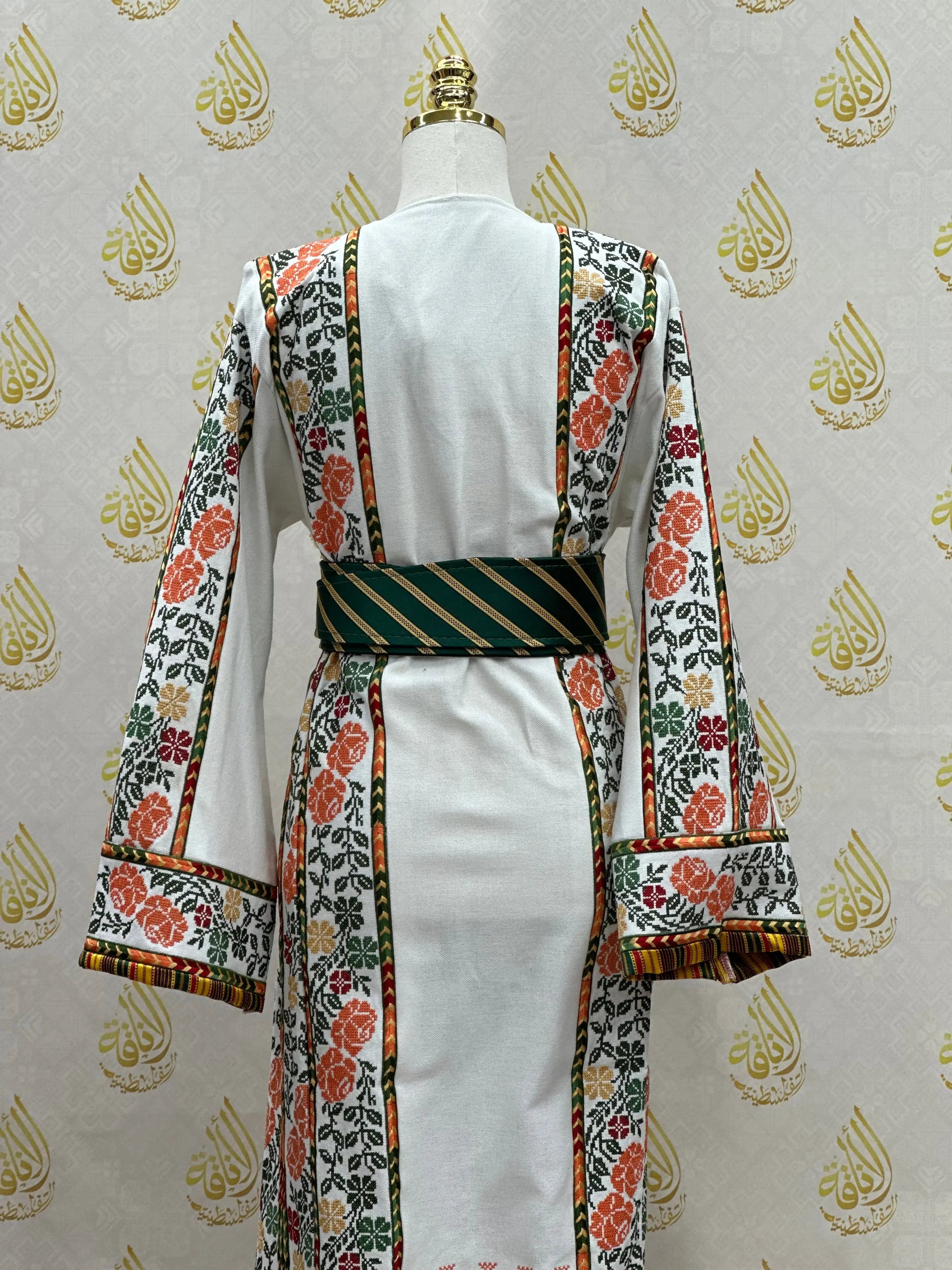 Back view of Palestinian embroidered thobe in white with floral embroidery and striped belt