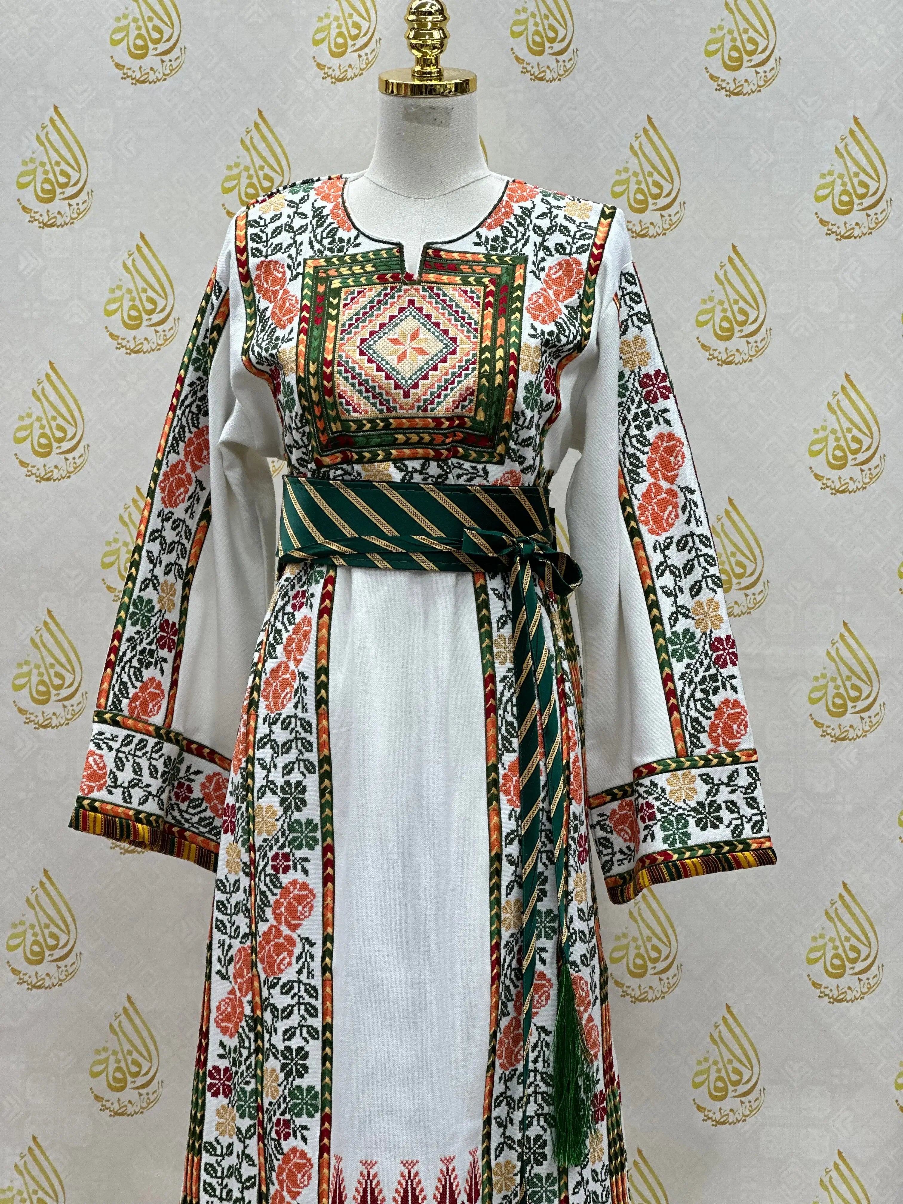 Palestinian embroidered thobe with intricate floral embroidery and a striped waist belt by Palestinian Elegance