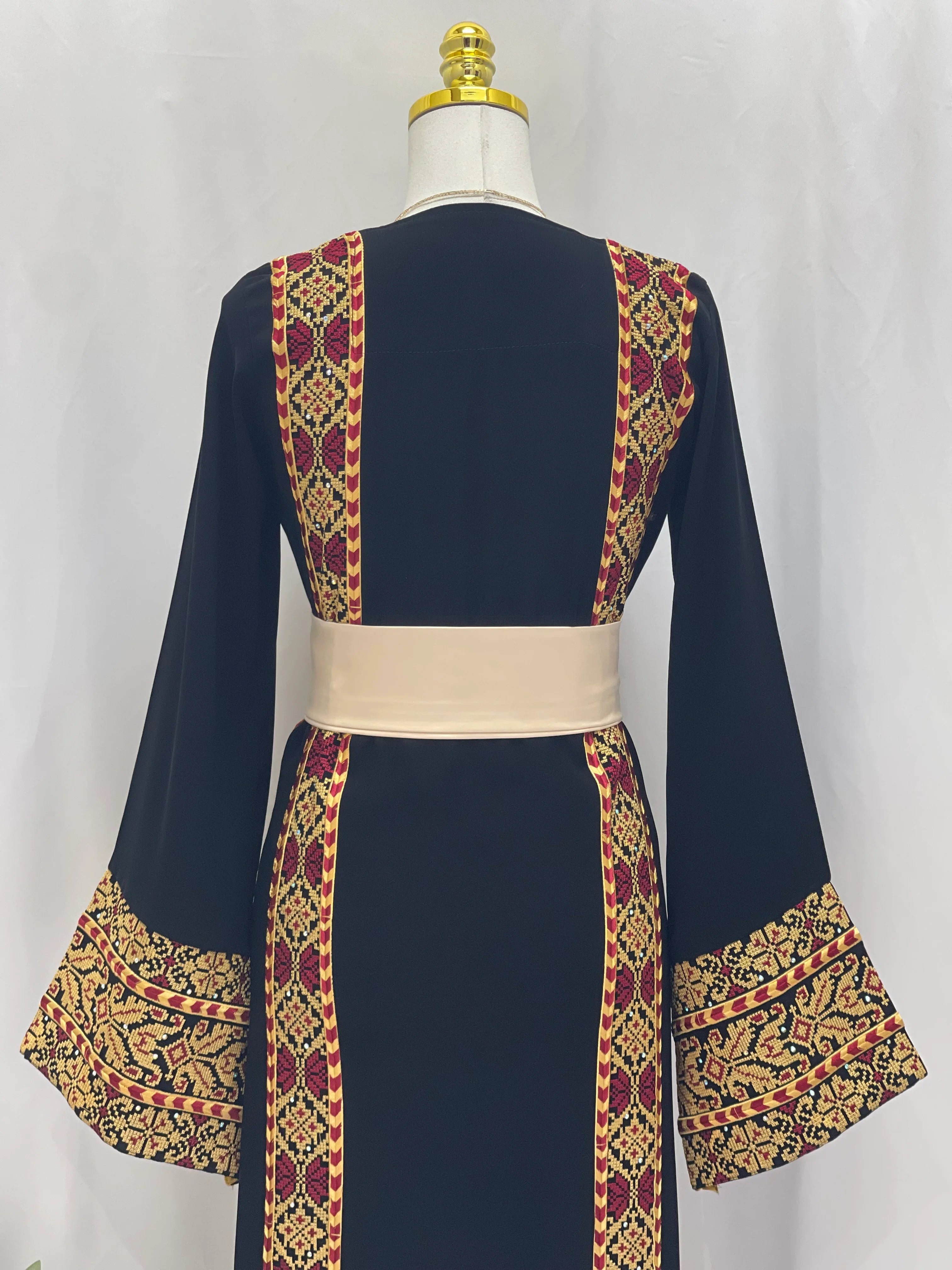 Palestinian embroidered thoub in navy with intricate red and gold traditional embroidery and wide sleeves