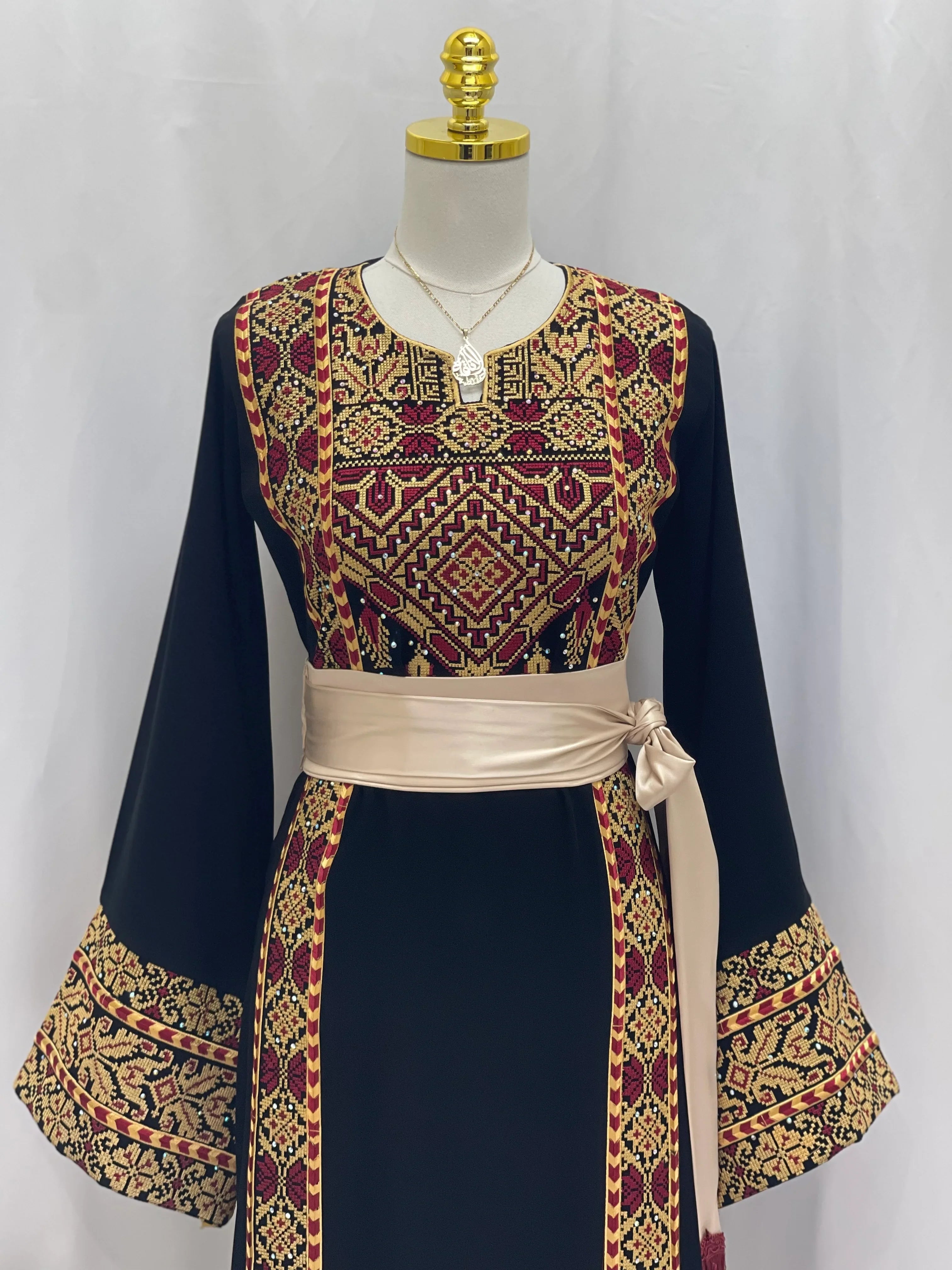 Palestinian embroidered thoub by Palestinian Elegance featuring intricate red and gold traditional embroidery