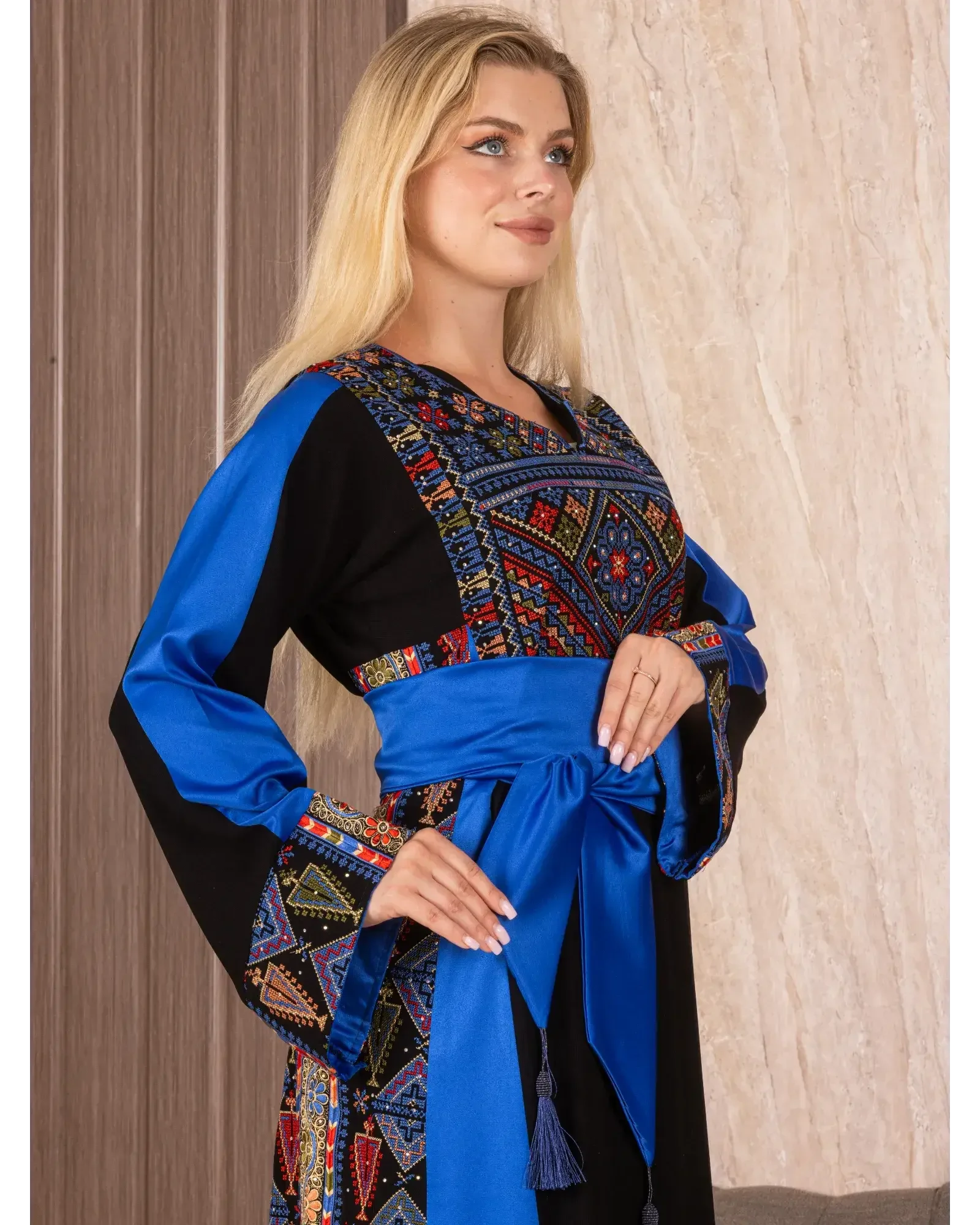 Palestinian embroidered thoub with colorful traditional patterns and blue sash by Palestinian Elegance