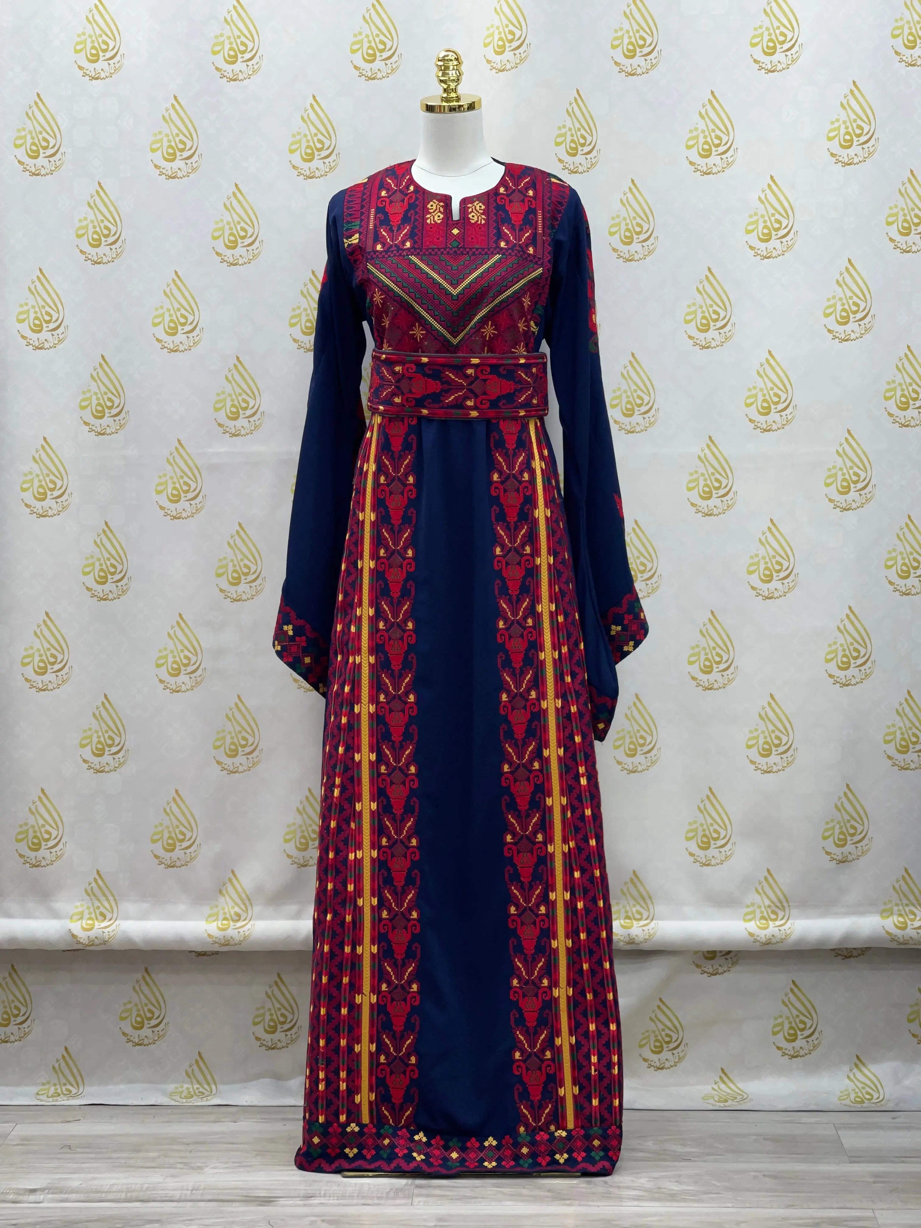 Palestinian embroidered thoub dress with intricate red and gold embroidery on navy blue fabric by Palestinian Elegance