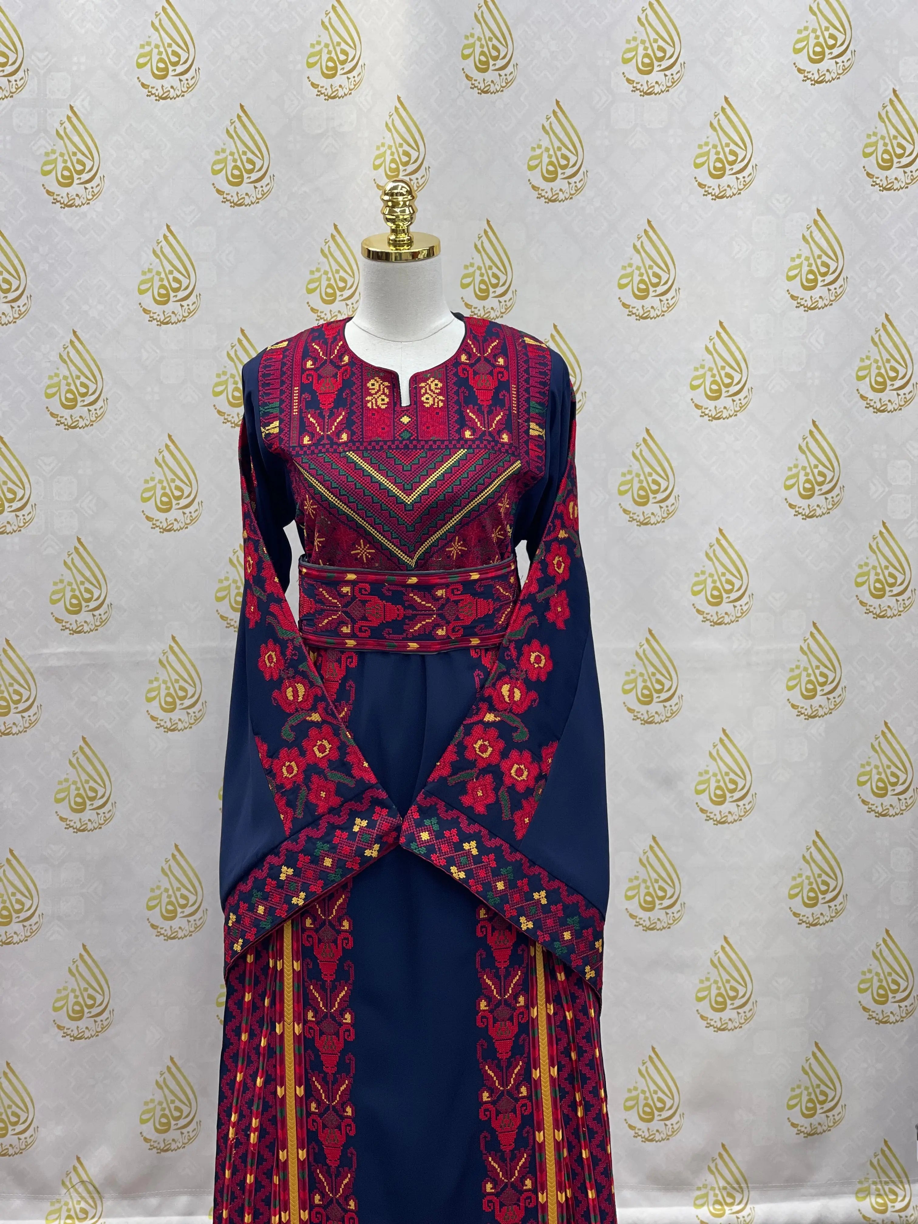 Palestinian embroidered thoub in navy blue with intricate red and pink traditional embroidery by Palestinian Elegance