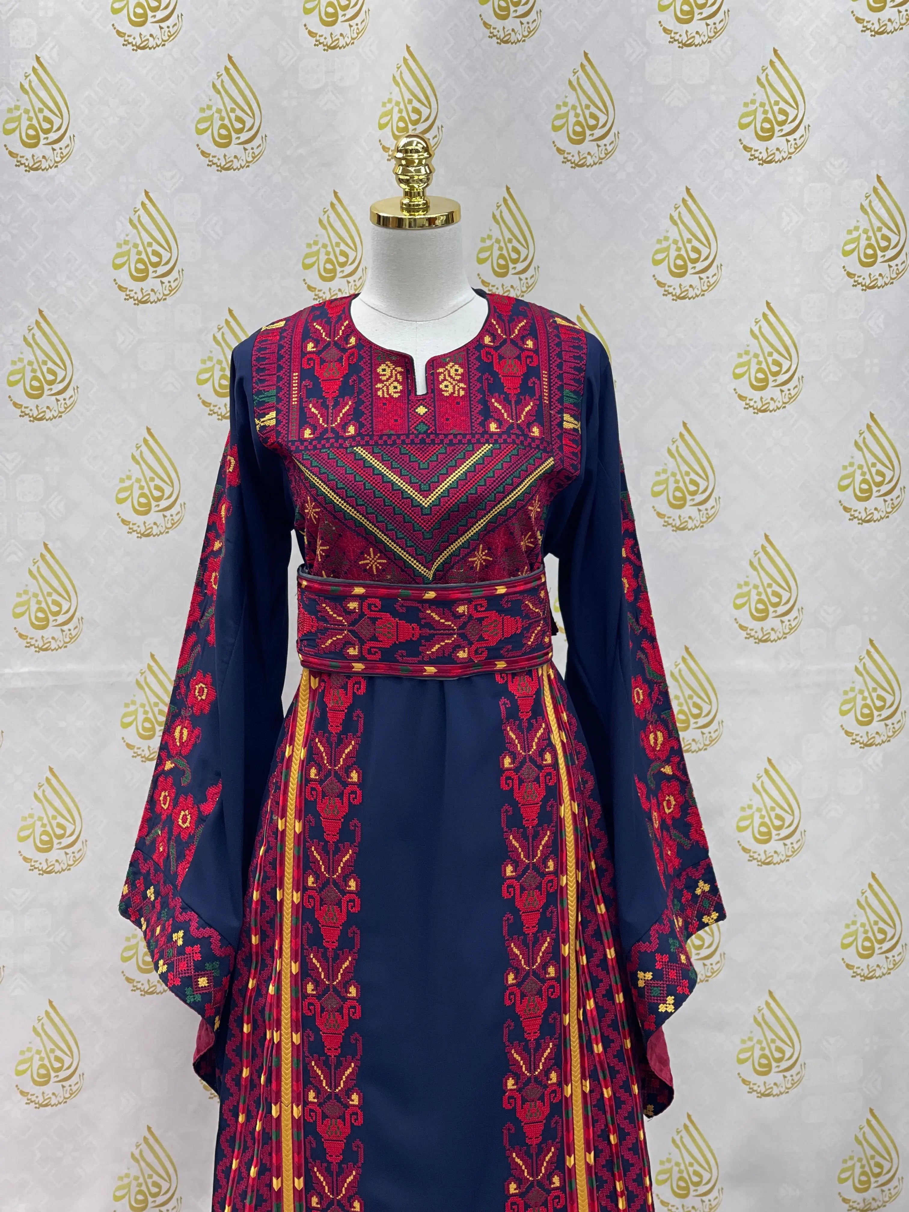 Palestinian embroidered thoub by Palestinian Elegance in navy blue with red and gold traditional embroidery details