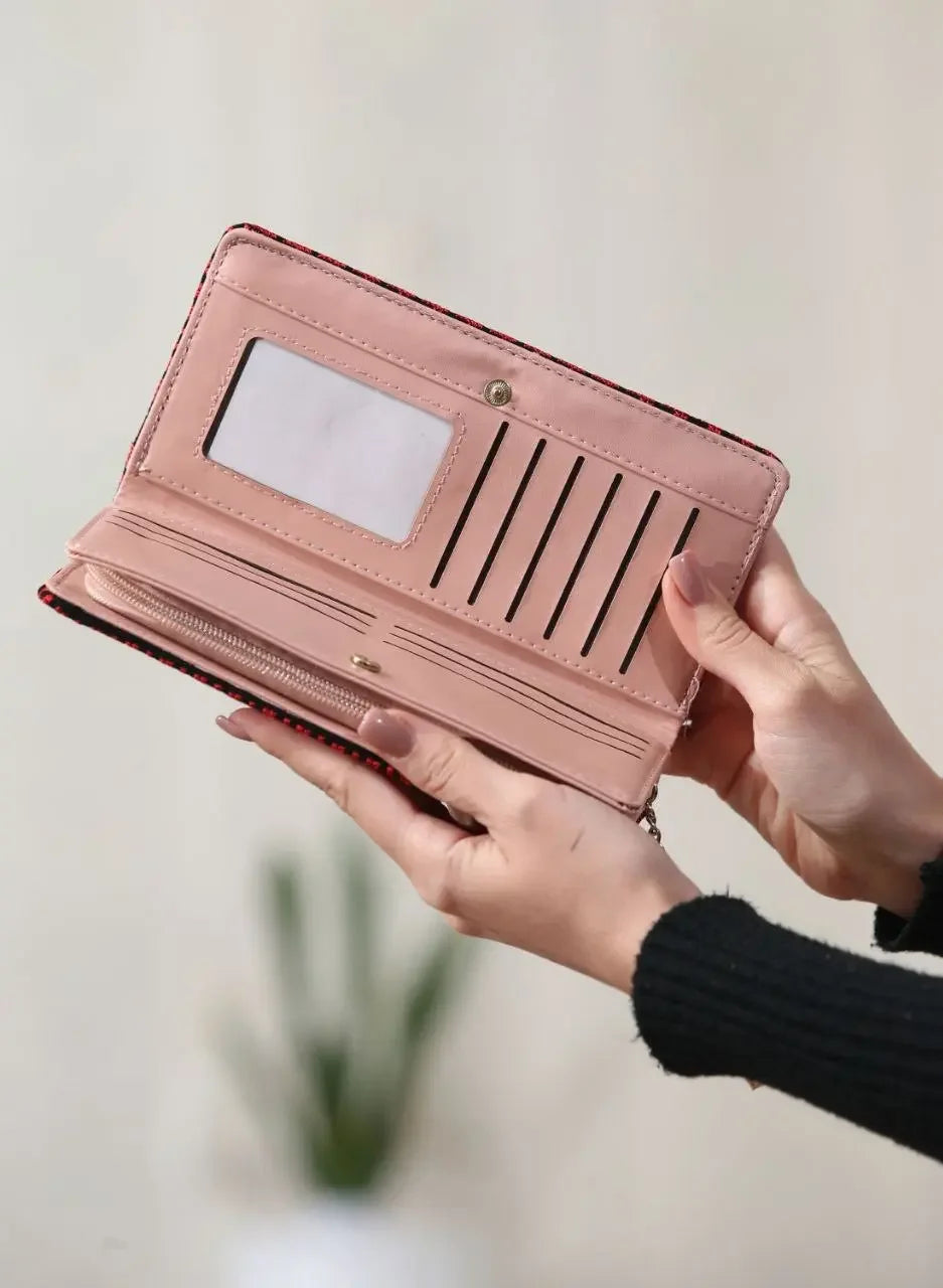 Palestinian embroidered wallet open showing multiple card slots and ID window held in hands