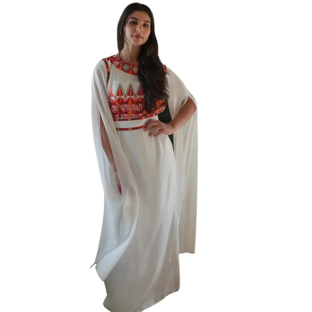 Elegant white Palestinian embroidery dress with vibrant red and orange traditional patterns by Palestinian Elegance