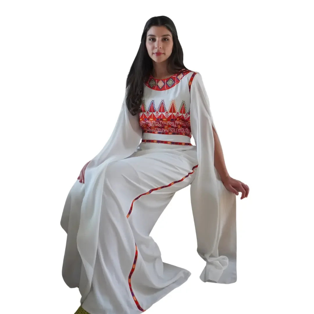White Palestinian embroidery dress by Palestinian Elegance featuring traditional red and multicolor embroidery details