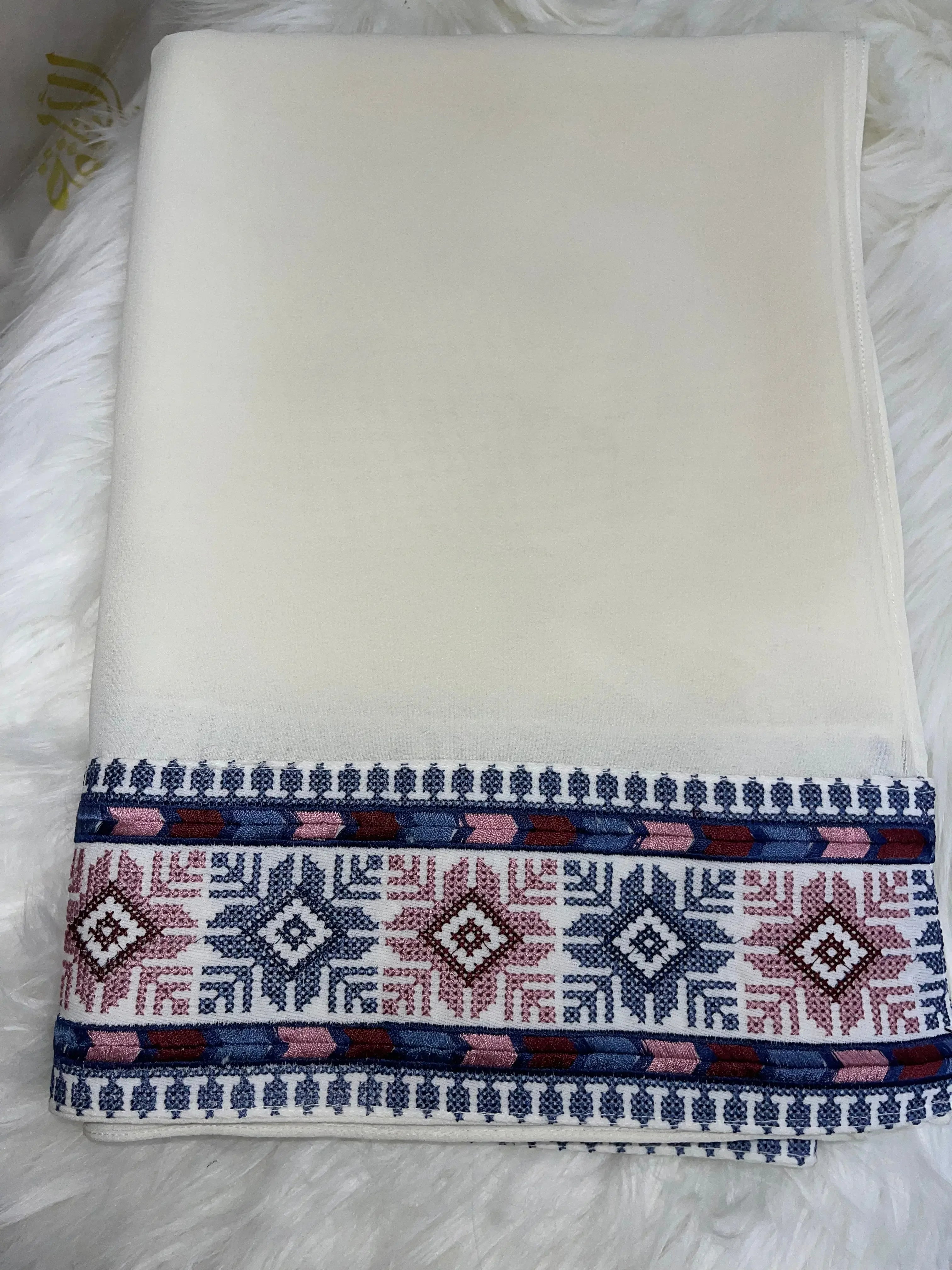 White shawl with detailed blue and pink Palestinian embroidery khirka pattern on the edges