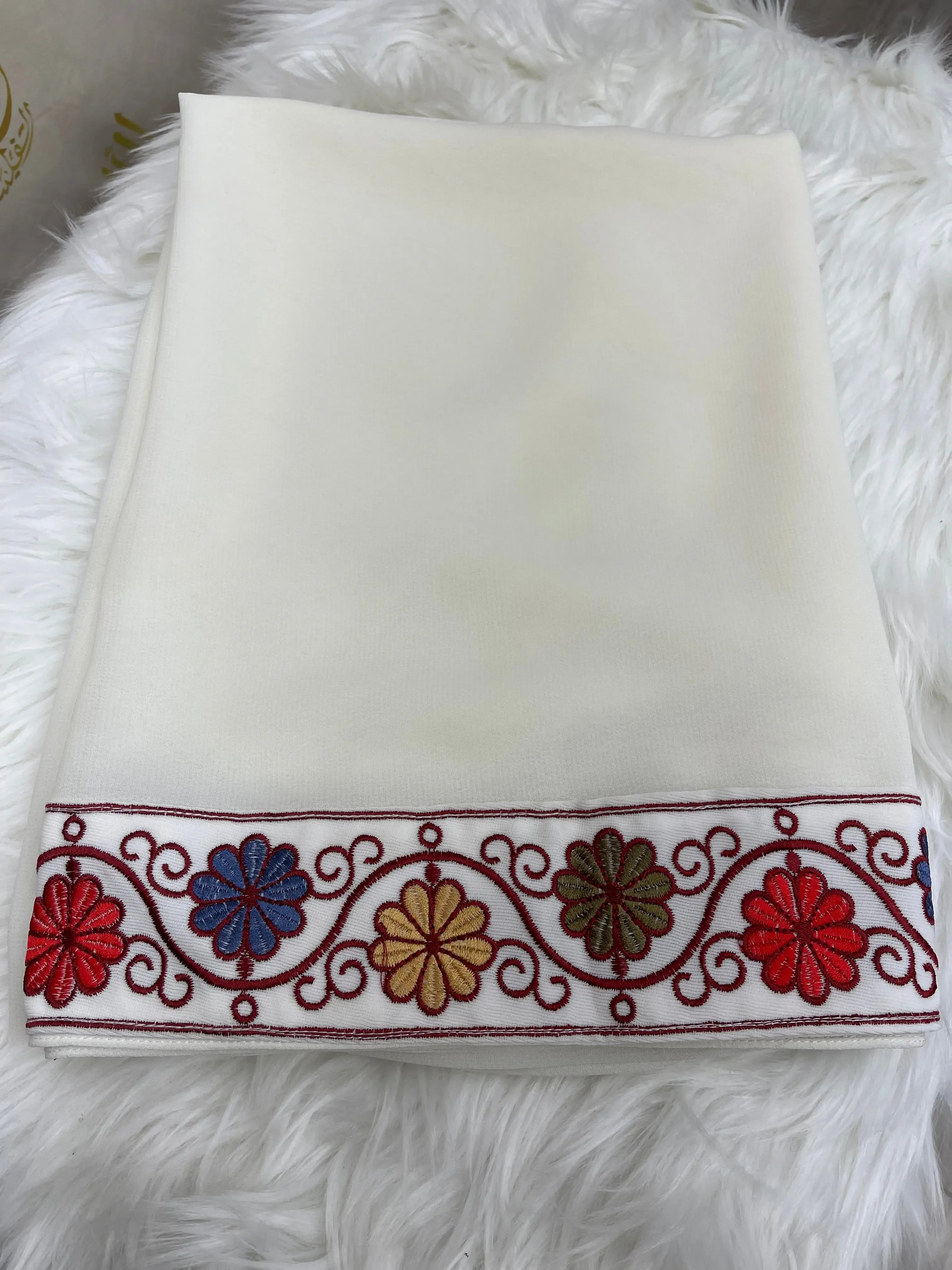 White shawl with colorful floral border embroidery by Palestinian Elegance featuring Palestinian embroidery khirka