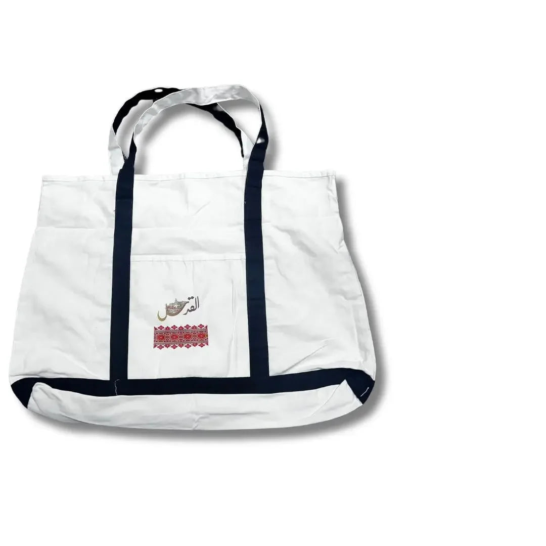White Palestinian embroidery tote with black handles and traditional red embroidery detail
