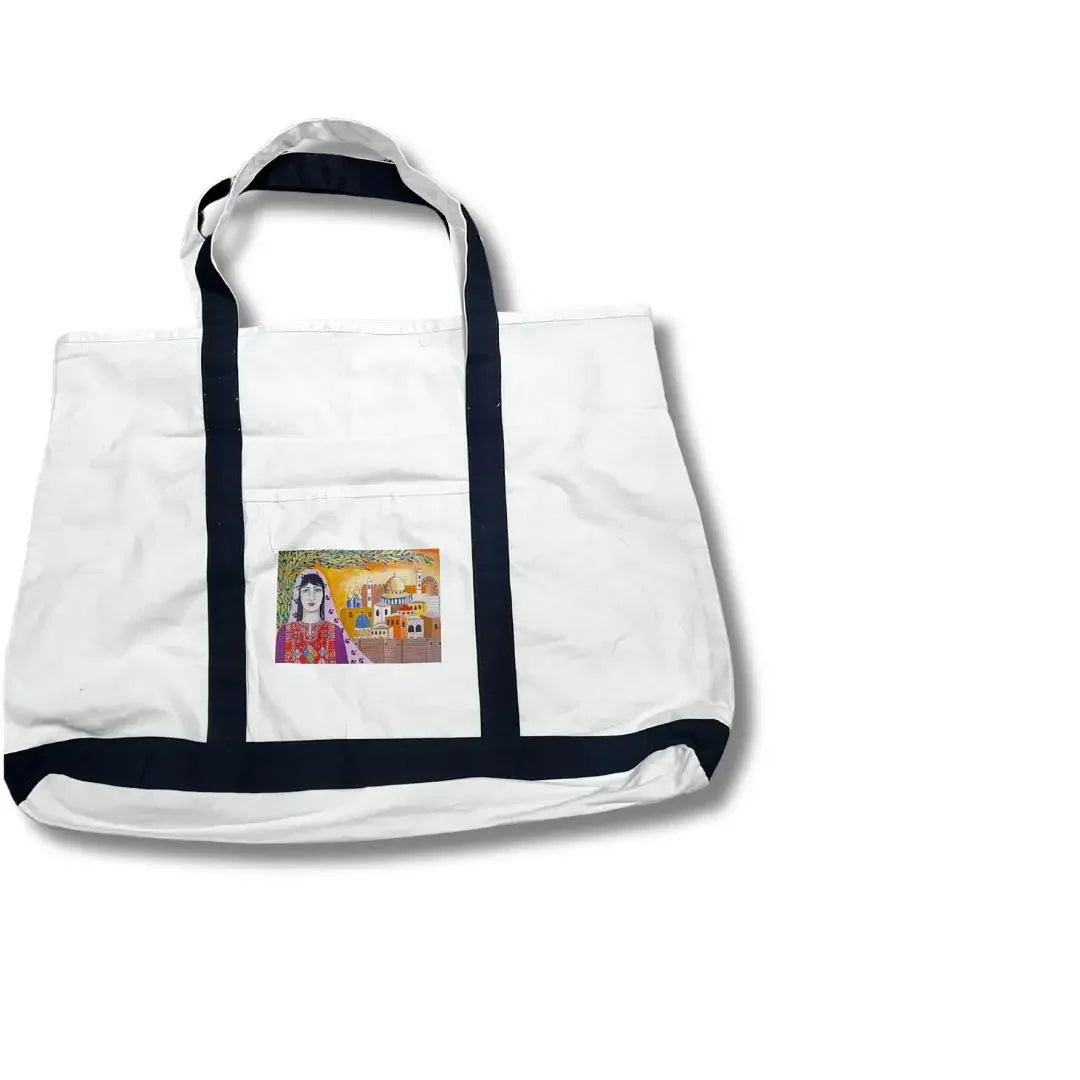 White Palestinian embroidery tote with black handles and a colorful embroidered design on the front pocket
