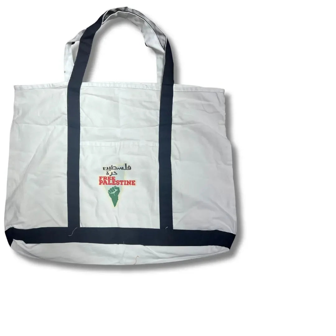 White Palestinian embroidery tote with black straps and Free Palestine embroidery on front pocket